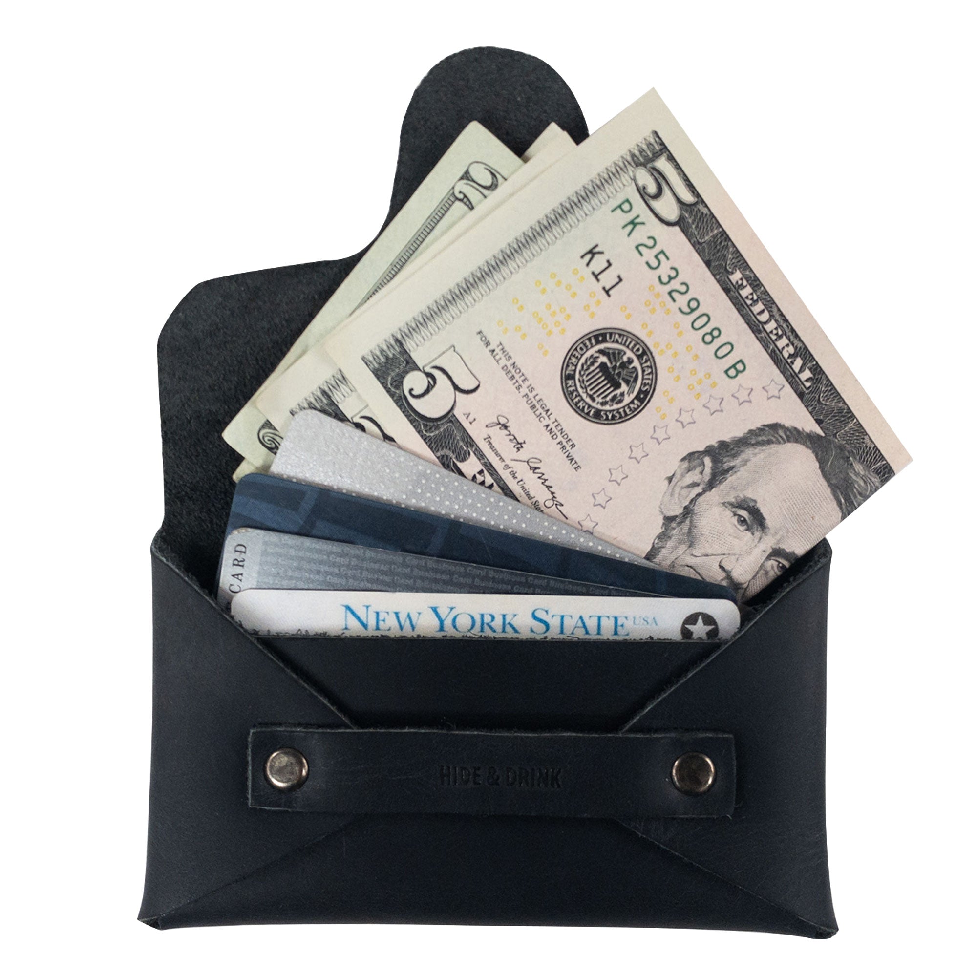 A Snapless Business Card Holder by Hide & Drink filled with cash and cards, showcasing its stylish and functional design. This vintage wallet is perfect for men and women, made from durable Full Grain Leather. Ideal as a sturdy pouch and money organizer, each piece is hand cut and sewn, reflecting artisan craftsmanship from La Antigua Guatemala and Oaxaca Mexico.