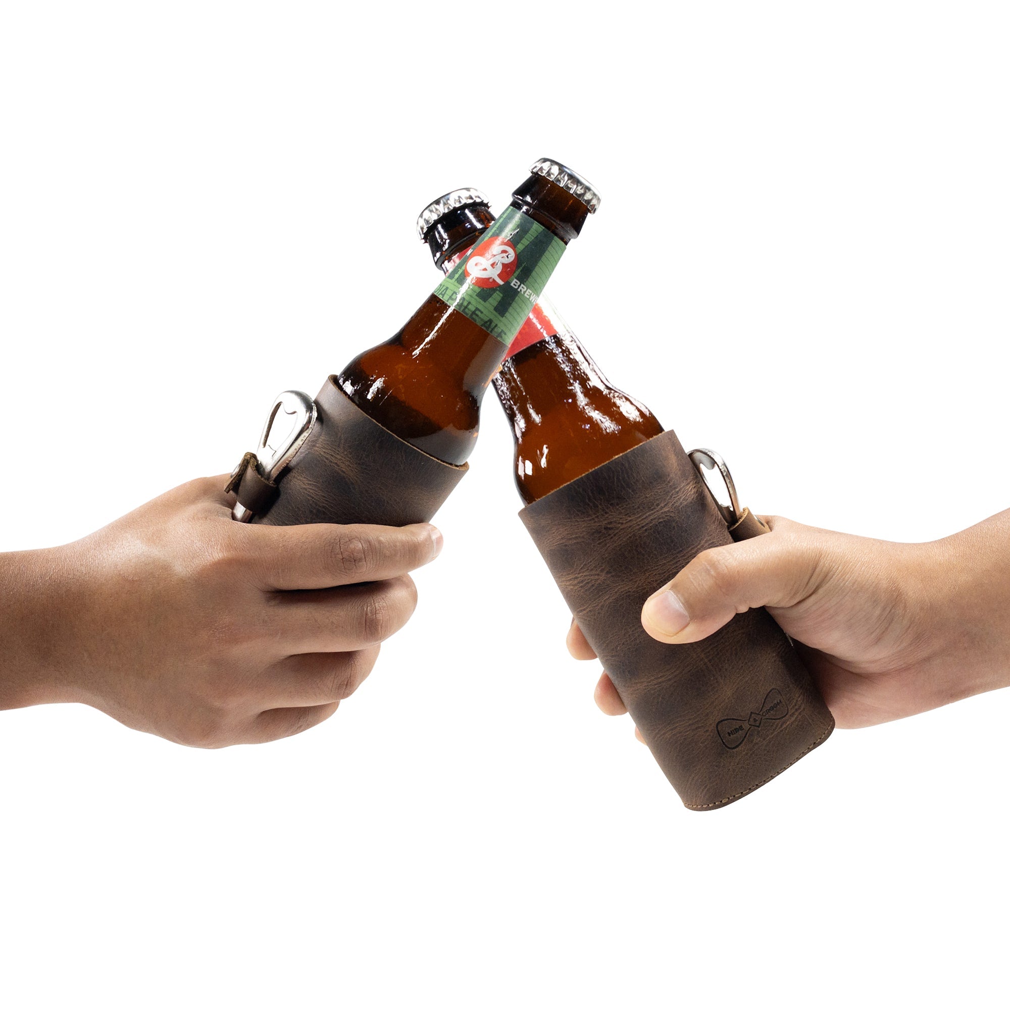 Two friends toasting with Hide & Groom Beer Bottle Sleeve Set of 2, made from premium full grain leather. The collapsible design and handy bottle opener slot make these perfect for weddings and Best Man accessories, handcrafted in La Antigua Guatemala.
