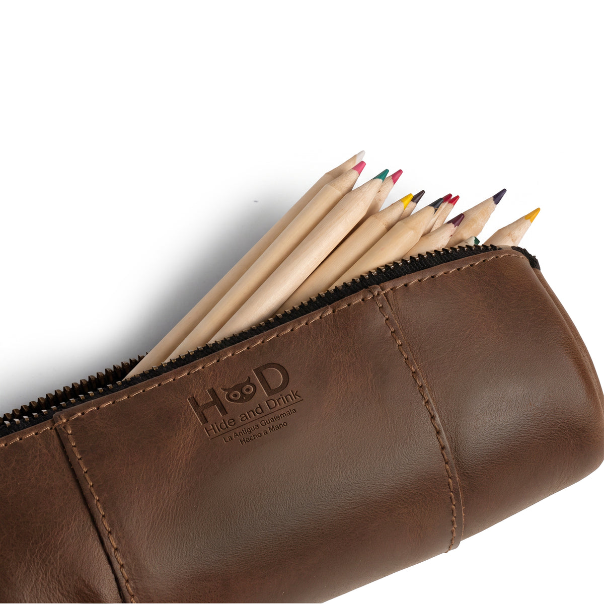 Utility Cylinder Case by Hide & Drink filled with pens, demonstrating its use for office supplies and personal items. This handmade bag features a rustic design and Full Grain Leather craftsmanship. Cylinder Case, Classic Bag, Handmade, Rustic.