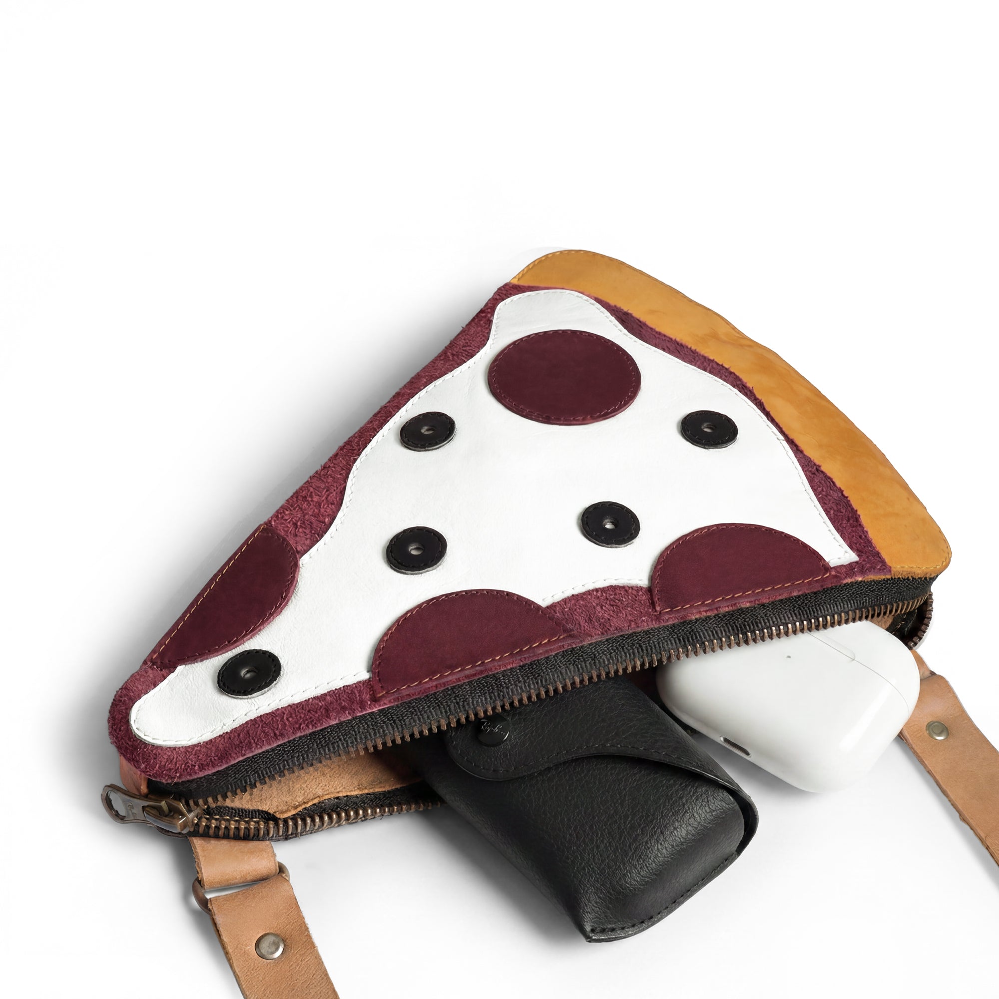 An open Pizza Slice-Shaped Shoulder Bag by Tudi Frudi showcasing the spacious interior, crafted from Full Grain Leather. This unique messenger bag is hand cut and fire branded, reflecting artisan skills from La Antigua Guatemala and perfect for stylish storage.