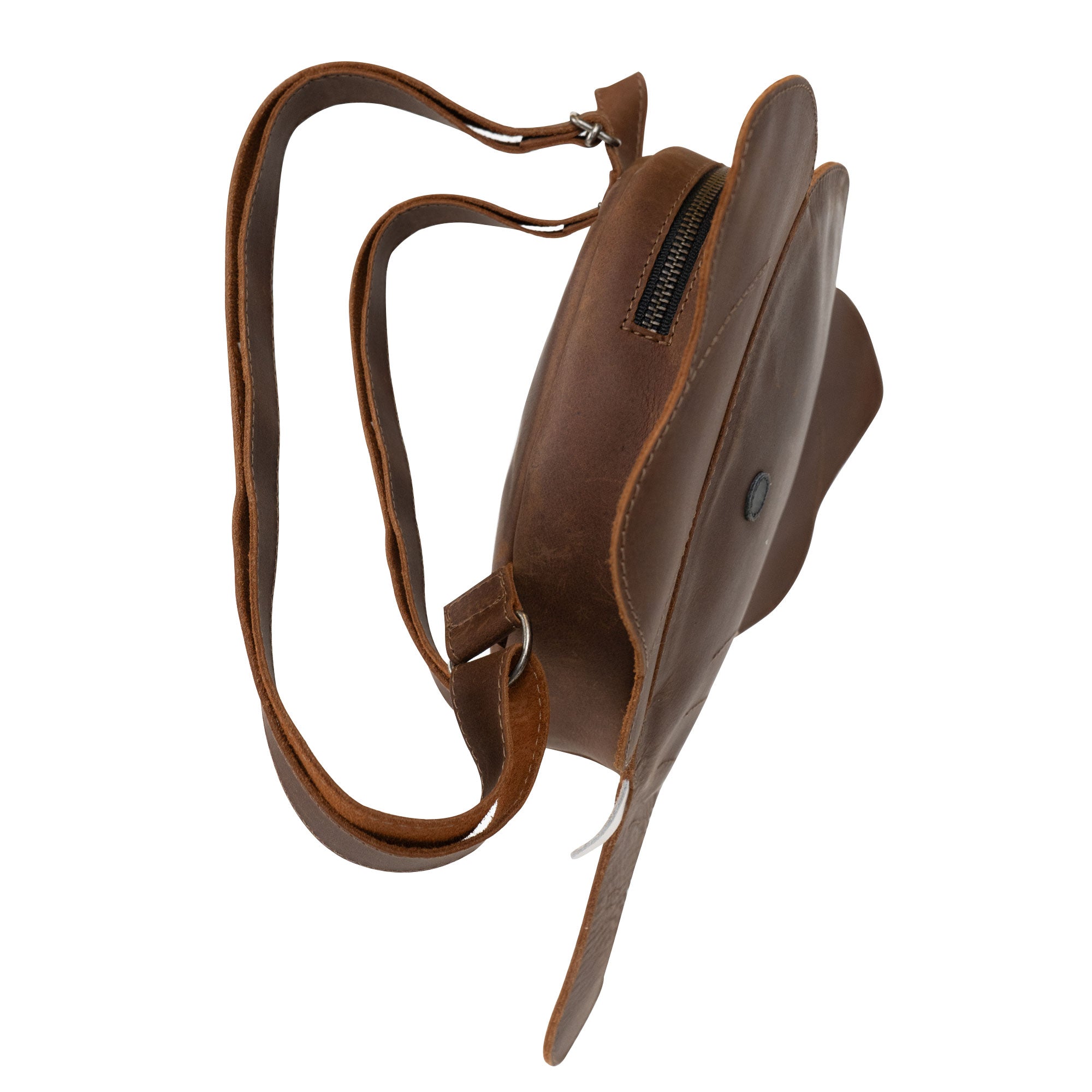 Side view of the Elephant-Shaped Backpack from Hide & Play, showcasing its unique leather design. This stylish Elephant-Shaped Shoulder Bag doubles as a Messenger Bag, crafted from durable Full Grain Leather. Each piece is handmade in La Antigua Guatemala by StockyardX artisans, combining functionality and charm.