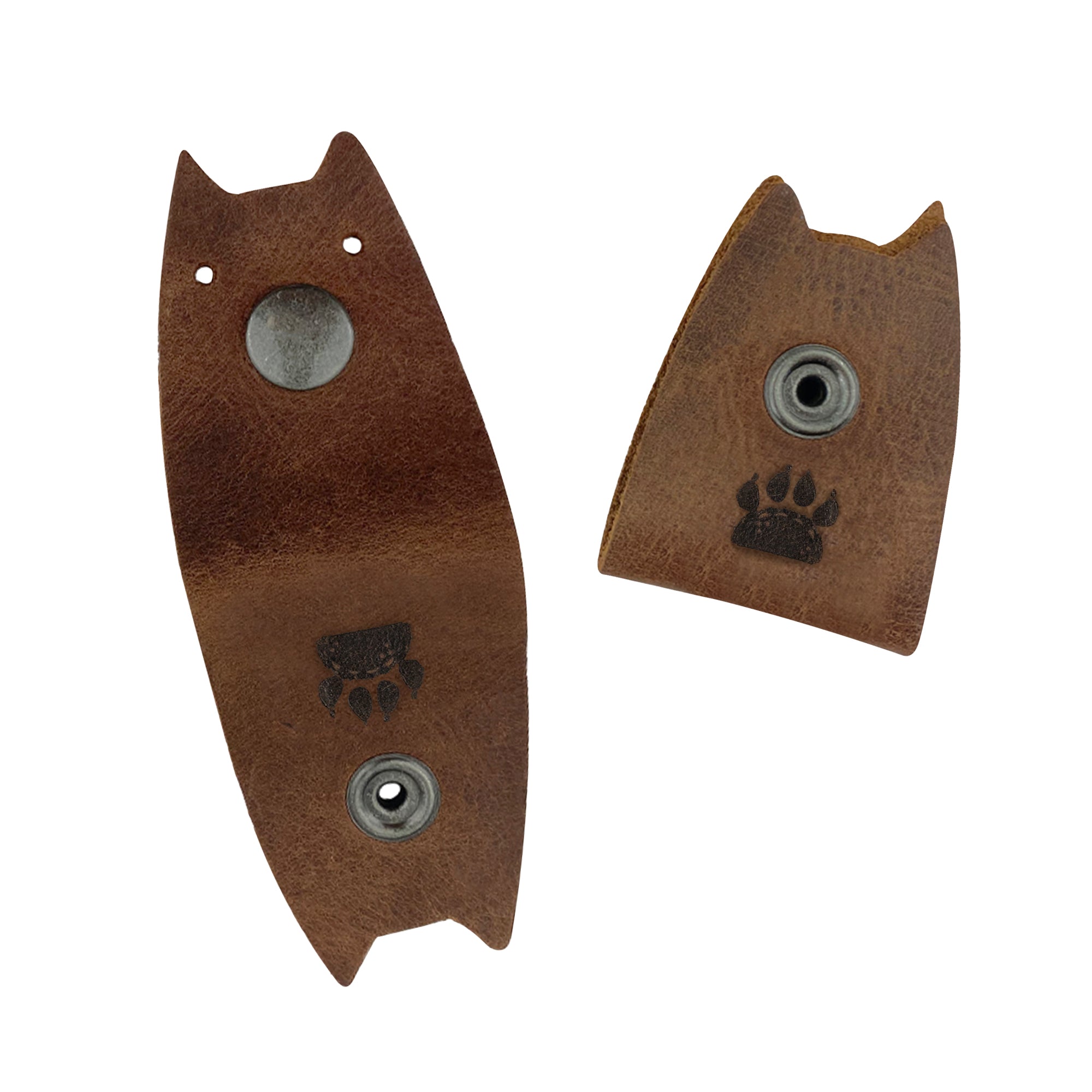 Close-up of Taco Dog's Cat Cord Keeper (2 Pack) showcasing its sturdy full grain leather and unique design. Convenient for wrapping your cables, earbuds, headphones, and chargers, these keepers snap together for easy management. Handmade in La Antigua Guatemala & Oaxaca Mexico embracing artisan quality.