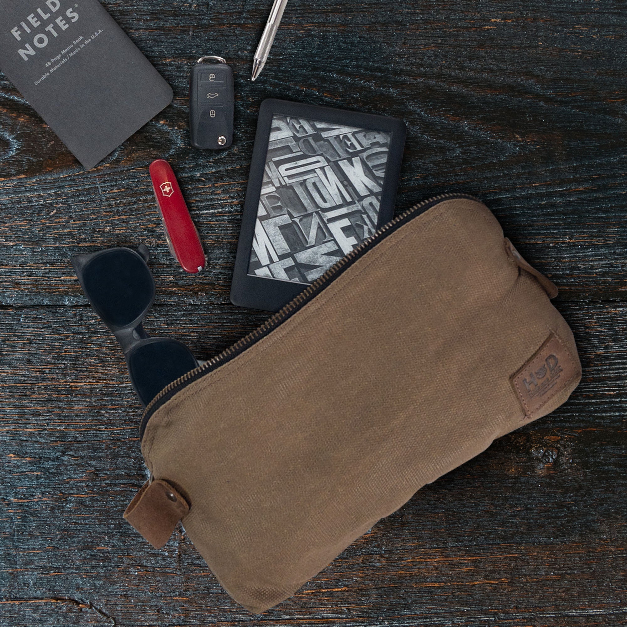 Dopp Kit Utility Bag by Hide & Drink displaying its rugged construction with versatility for everyday essentials. This large rustic all-purpose Dopp Kit Utility Bag is artisans crafted from full grain leather, emphasizing quality hand cut and hand sewn techniques, handmade in La Antigua Guatemala & Oaxaca Mexico.
