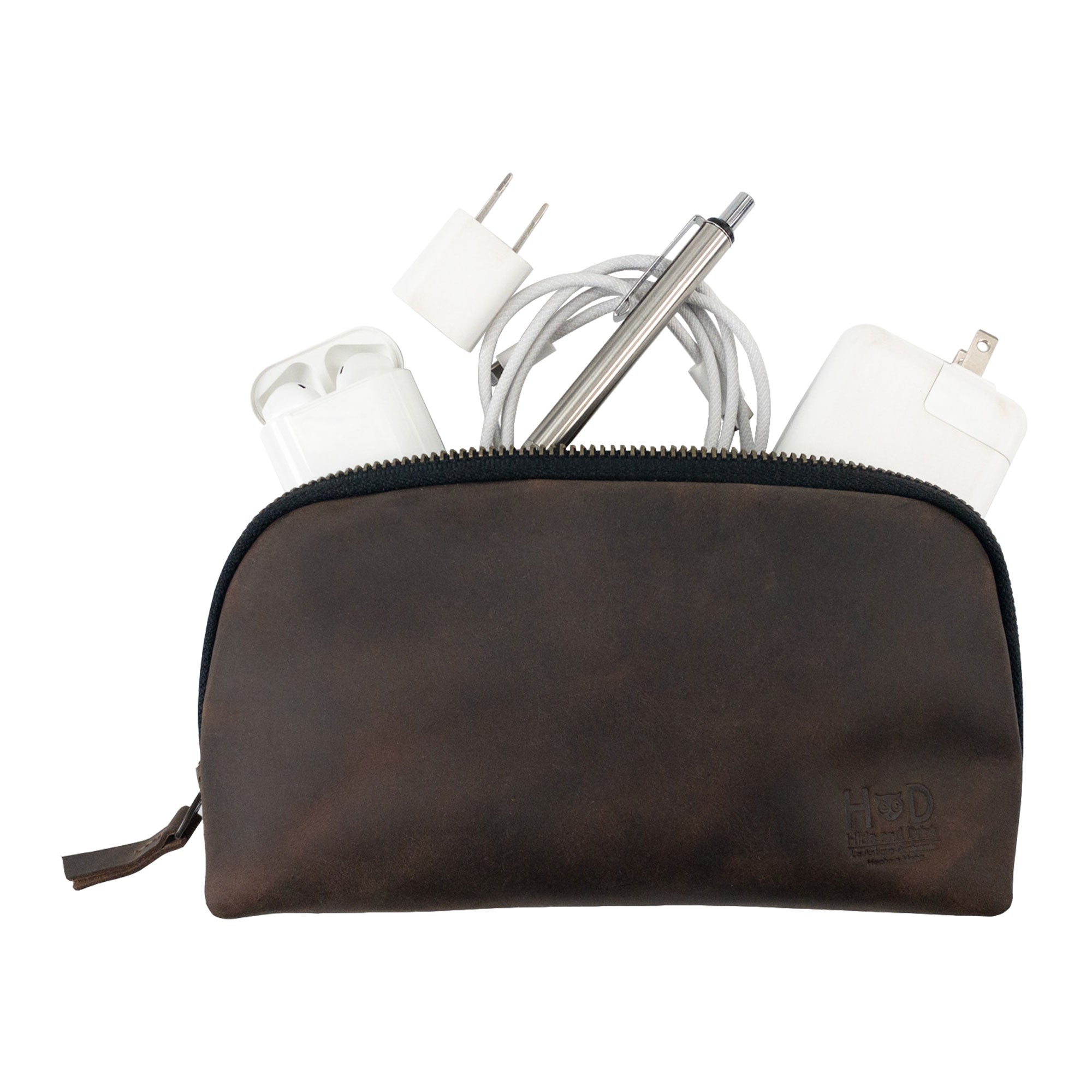 Hide & Drink's Small Tech Organizer filled with chargers and cables. This small tech bag offers a rustic look while being practical for everyday use. It's made from durable full grain leather, highlighting artisan techniques handmade in La Antigua Guatemala & Oaxaca Mexico.