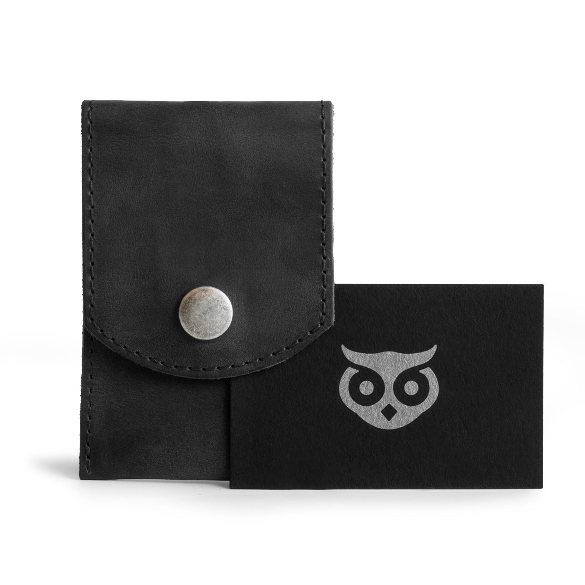 Hide & Drink Nail Clipper Case in black leather displayed with branded card, showcasing its durability and aesthetics. An ideal travel accessory, this nail clipper case is crafted from full grain leather with artisan small batch production, hand cut, hand sewn, and fire branded, handmade in La Antigua Guatemala & Oaxaca Mexico.