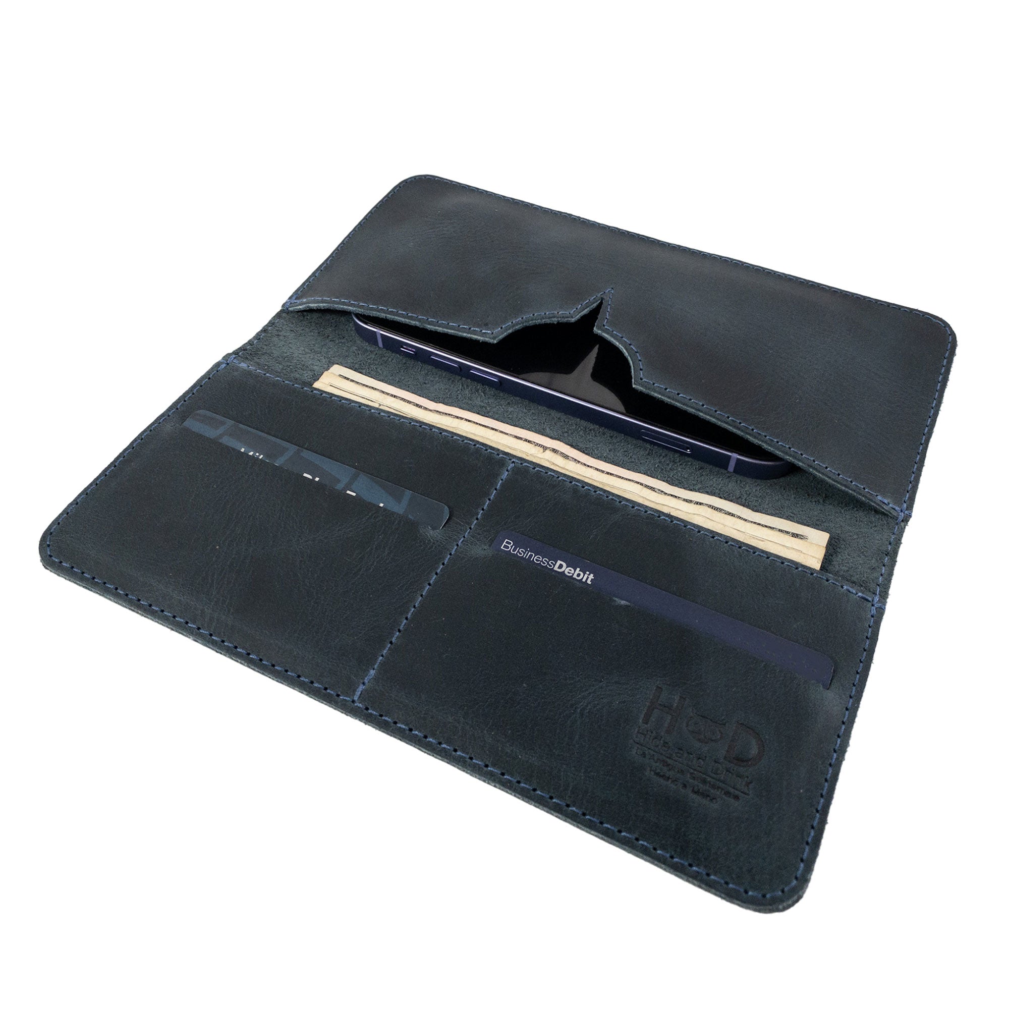 Exterior view of the closed bifold wallet for cellphone by Hide & Drink, highlighting its premium leather finish. This Bifold Wallet for Cellphone is designed for everyday convenience with a touch of elegance in Full Grain Leather. Experience the artisan craftsmanship from small batch production in La Antigua Guatemala & Oaxaca Mexico.