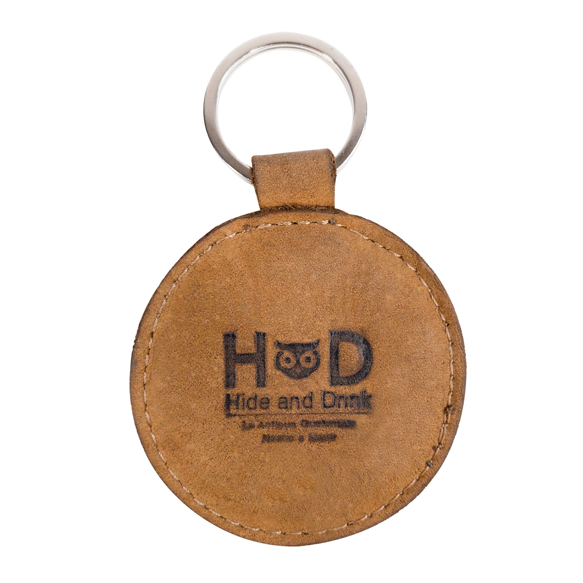 Back view of the Smiley Face Keychain by Hide & Drink displaying the brand logo. This key ring is crafted from premium Full Grain Leather, making it a stylish and durable accessory. An artisan-made piece, perfect for cute gifts and highlighting small batch production from La Antigua Guatemala.