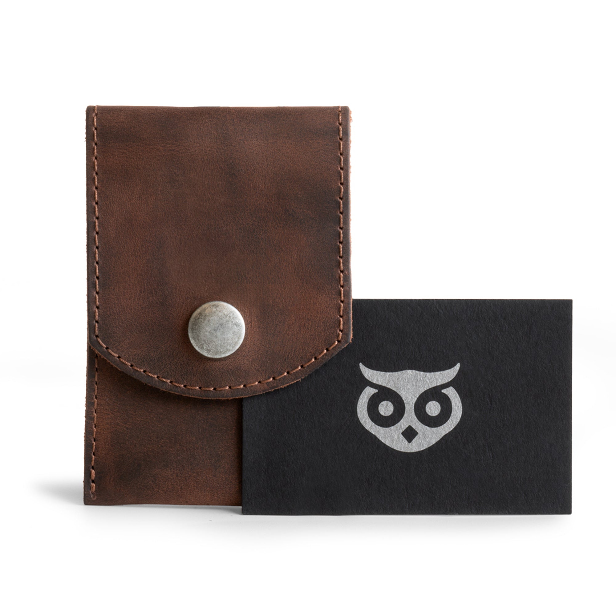 Hide & Drink Nail Clipper Case alongside a branded card, made from premium full grain leather. This nail clipper case is the perfect travel accessory, showcasing small batch production with hand cut, hand sewn, and fire branded craftsmanship. Handmade in La Antigua Guatemala & Oaxaca Mexico.