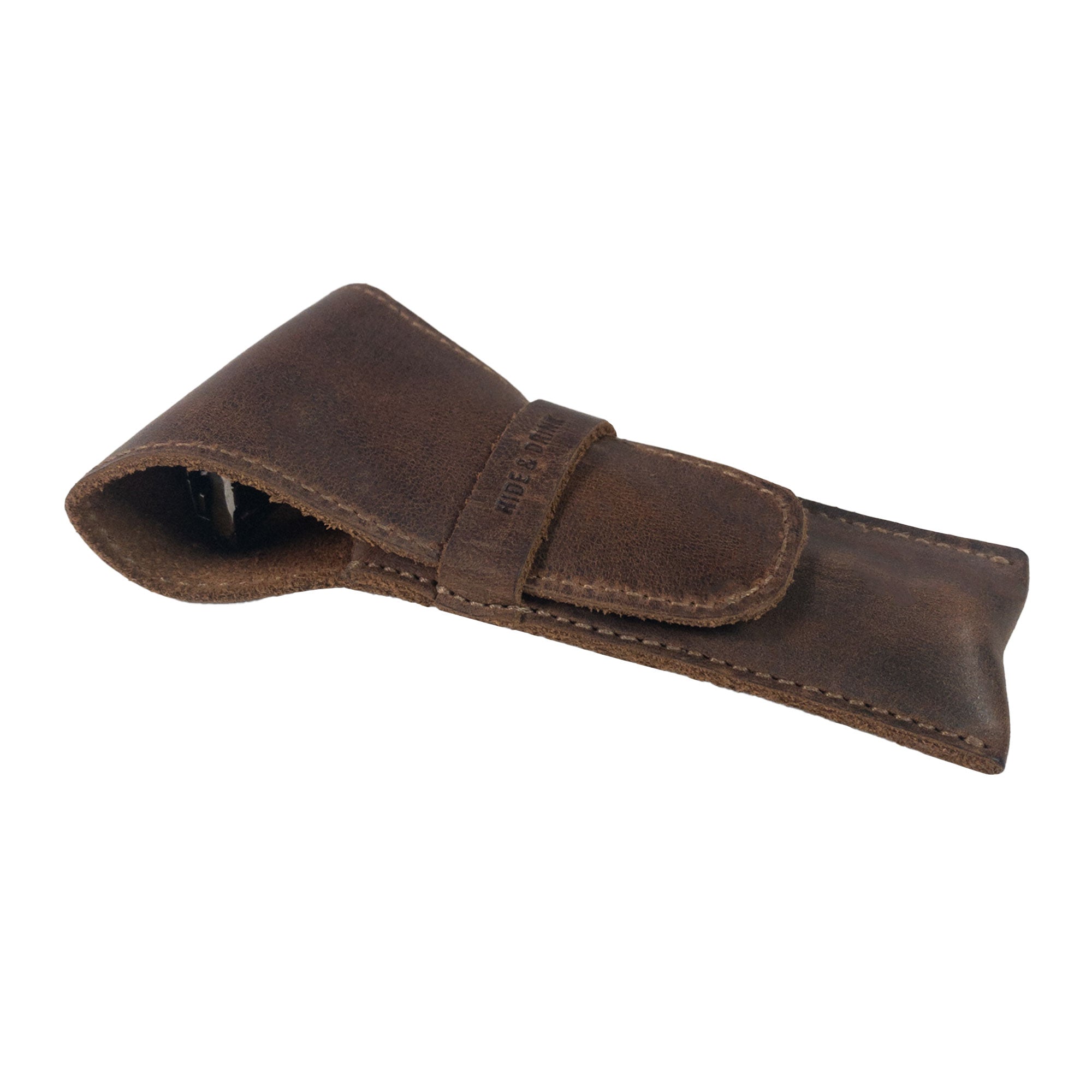 Safety Razor Case by Hide & Drink, shown in a slightly curled position, highlighting its durable Full Grain Leather construction. Perfect for storing shaving accessories, this handmade piece reflects quality artisan craftsmanship.