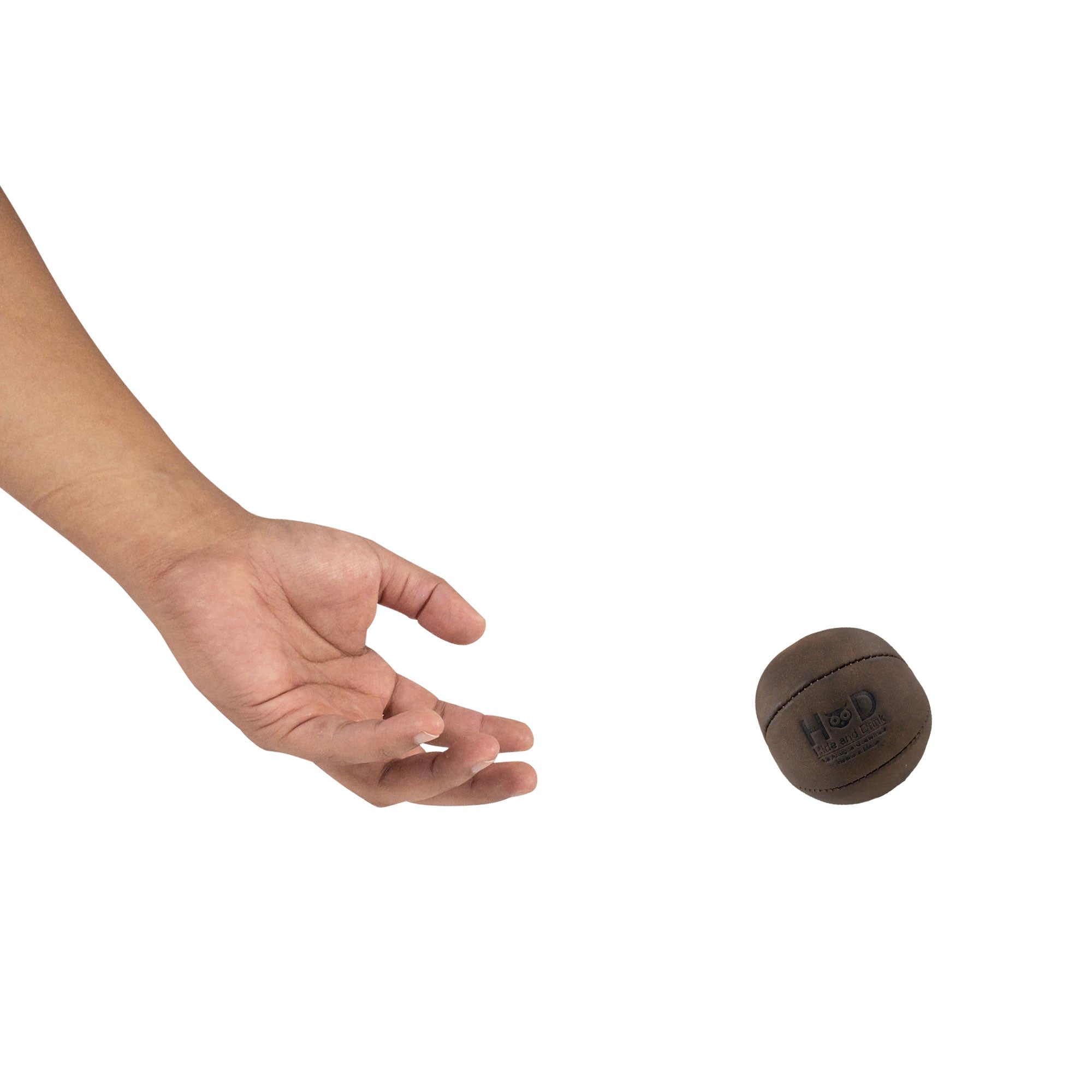 Hide & Drink Stress Ball released from a hand, perfect for relieving fidgeting and anxiety. The squishy tension accessory showcases classic style made from durable full grain leather, handcrafted in La Antigua Guatemala.