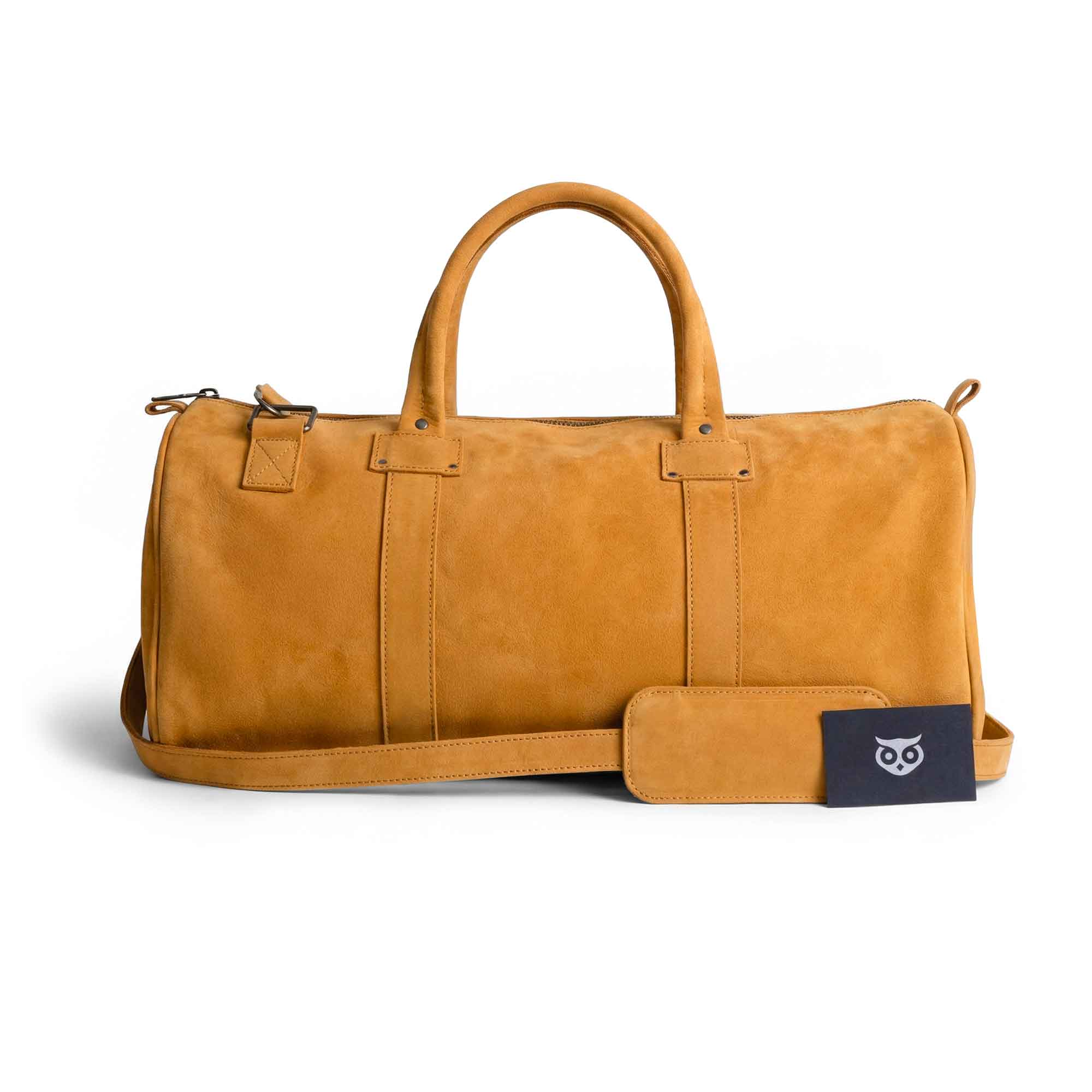 Detail view of the Classic Duffle Bag by Hide & Drink in orange suede, highlighting craftsmanship and quality. This stylish Full Grain Leather Classic Duffle Bag serves as a versatile Messenger Bag with adjustable strap and zipper closure, handmade in La Antigua Guatemala & Oaxaca Mexico.
