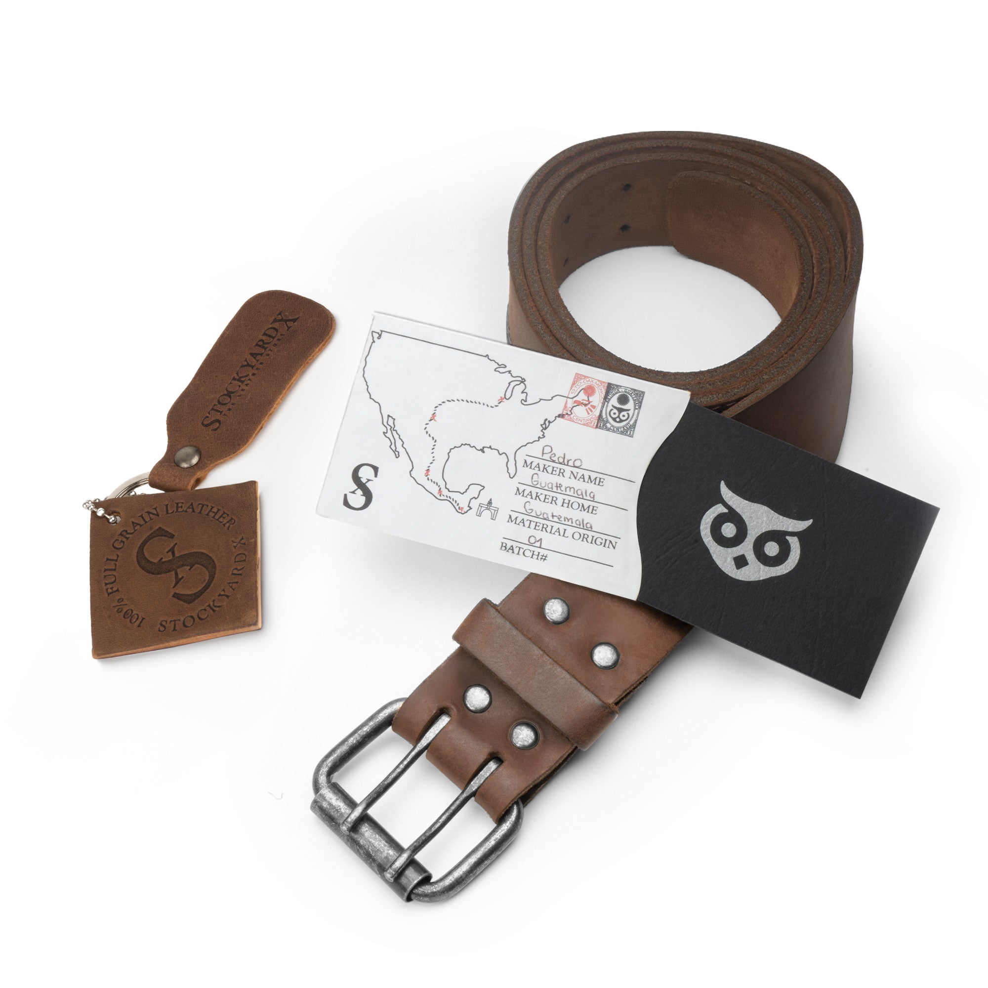 Showcasing the Reinforced Double Prong Buckle Belt by Hide & Drink with packaging, highlighting its rustic design. This belt is 1.5 in. wide and constructed from full grain leather, demonstrating stockyardX quality through small batch production, hand cut, hand sewn, and fire branded artisanal skills, made in La Antigua Guatemala & Oaxaca Mexico.