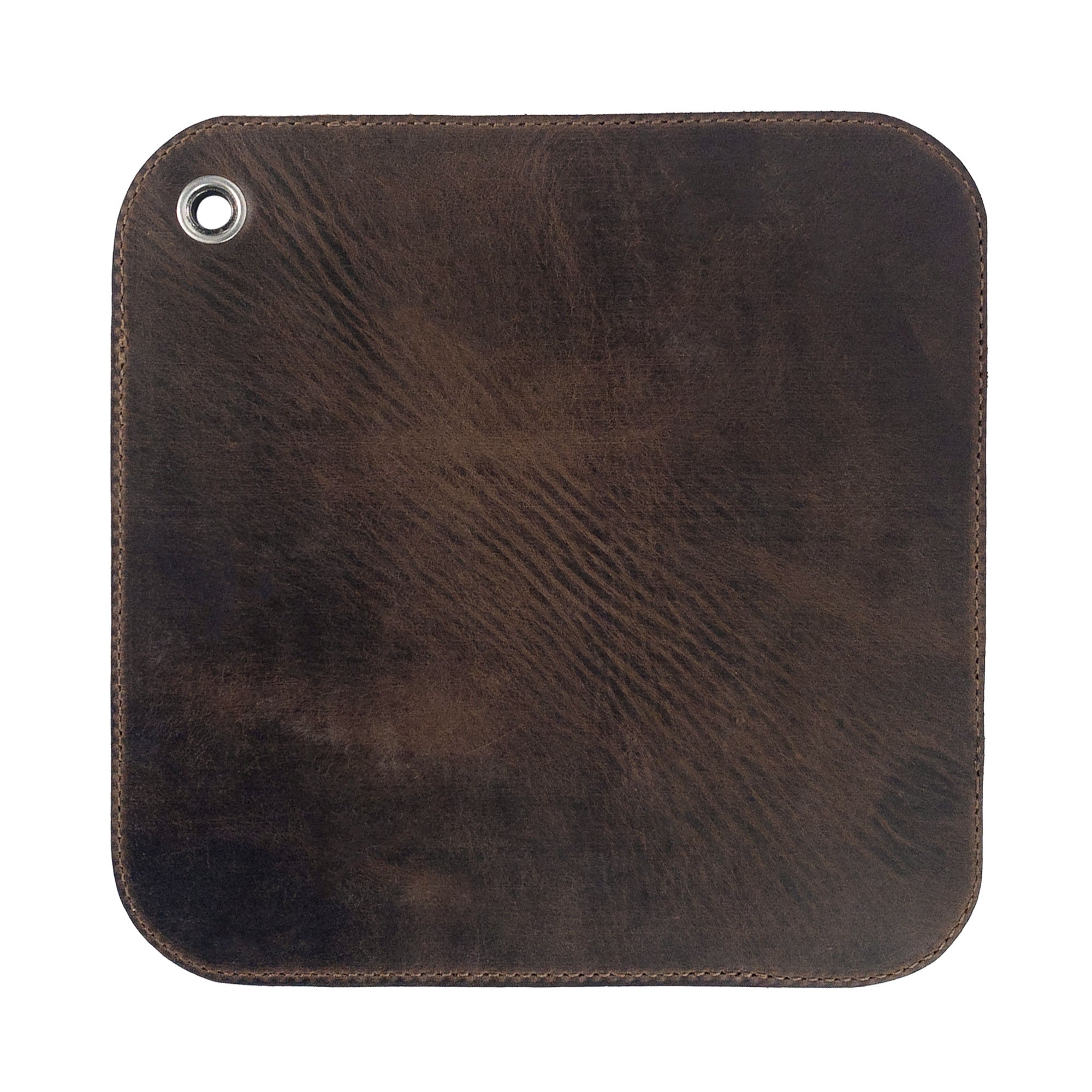 An elegant view of the underside of the Cast Leather Co. Leather Oven Mitt & Trivet, highlighting its smooth full grain leather finish. This versatile hot pot pad (potholder) represents the essence of artisan craftsmanship and small batch production, handmade in La Antigua Guatemala.