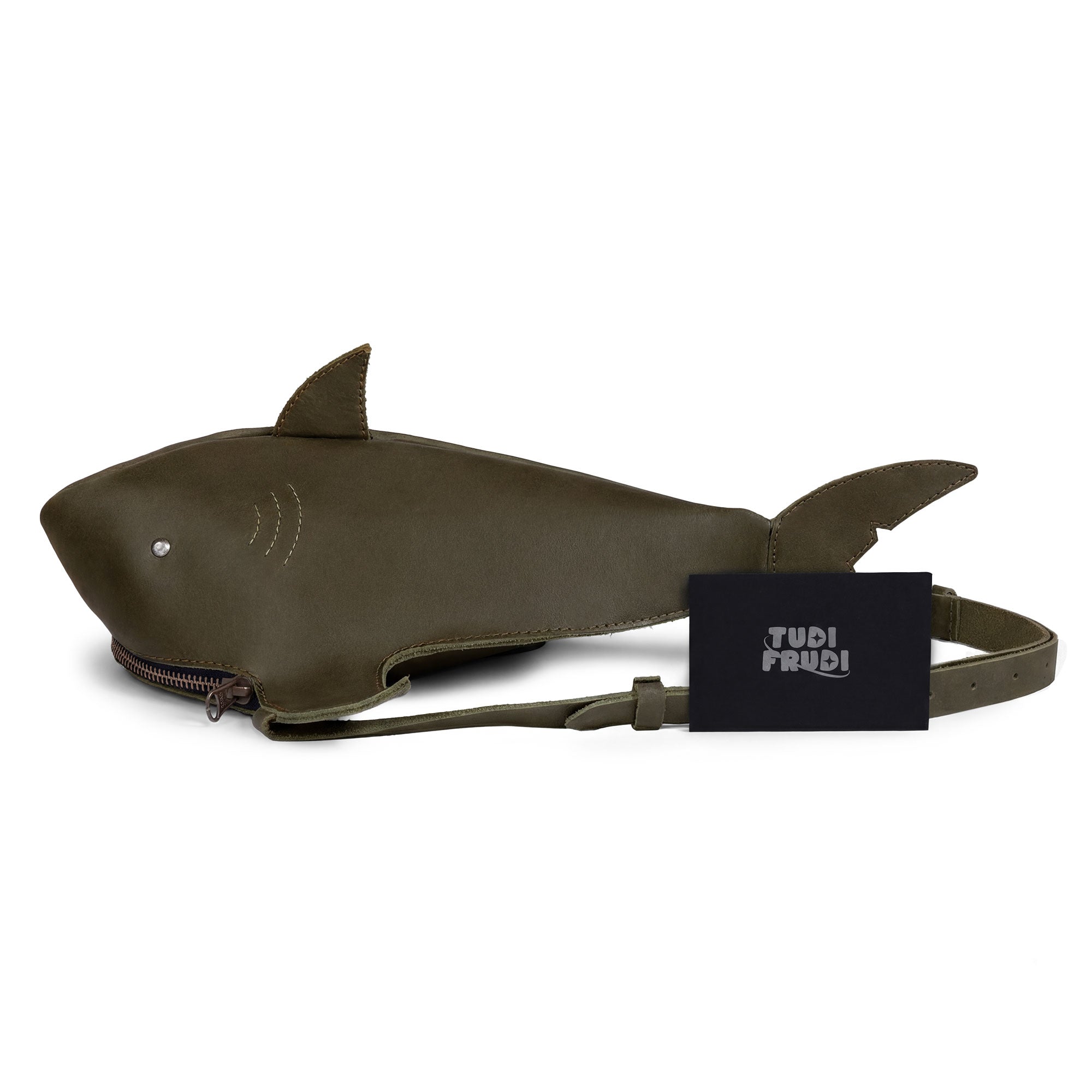 Shark-Shaped Shoulder Bag by Tudi Frudi displayed with its branding tag. This unique bag made from Full Grain Leather serves as a Crossbody or Messenger Bag and represents artisan craftsmanship, handmade in La Antigua Guatemala.