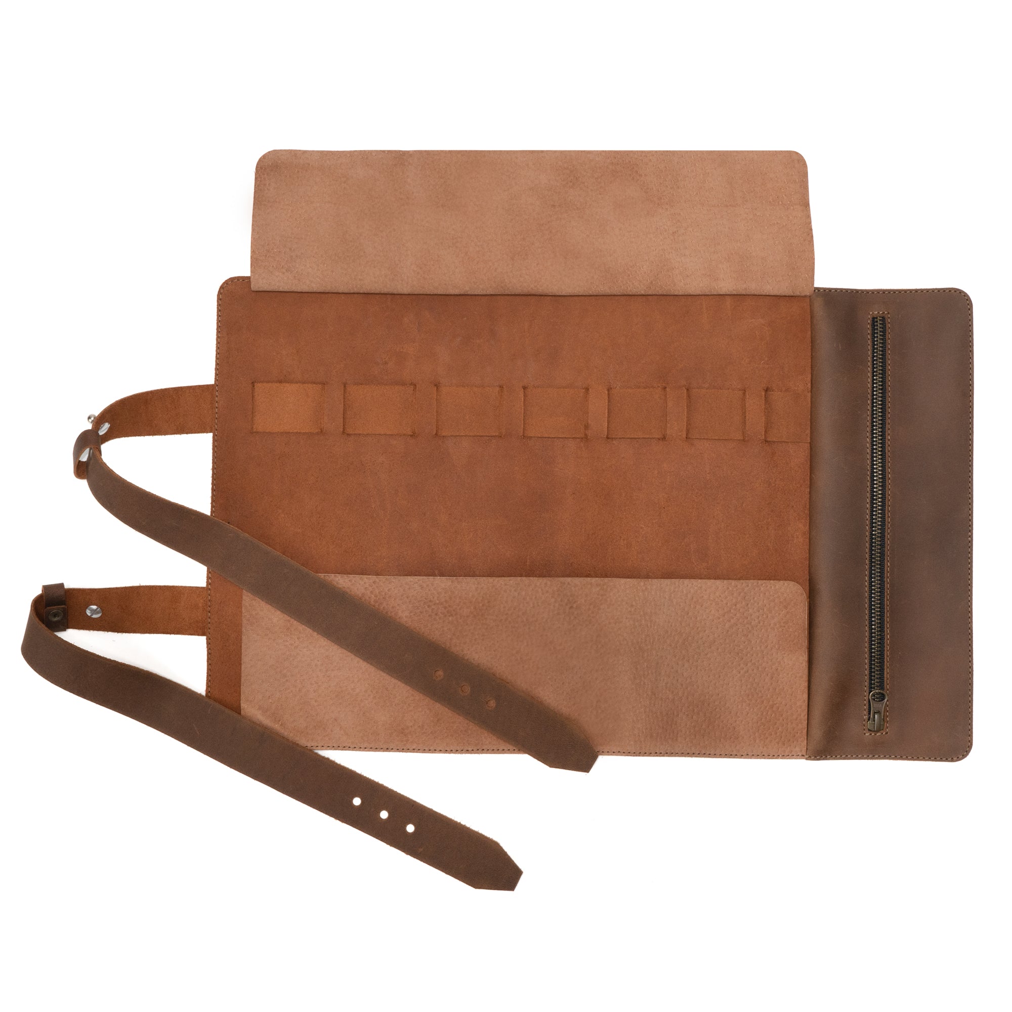 Interior view of a Tool Roll for Bikers revealing pockets and a zipper compartment, created by Hide & Ride. This Motorcycle Tool Bag is the ideal Universal Saddlebag for Motorcycle or Fork Bag for Bikers, expertly made of Full Grain Leather. Benefit from the reliability of Small Batch Production that features Hand Cut and Hand Sewn details, designed by artisans in La Antigua Guatemala & Oaxaca Mexico.