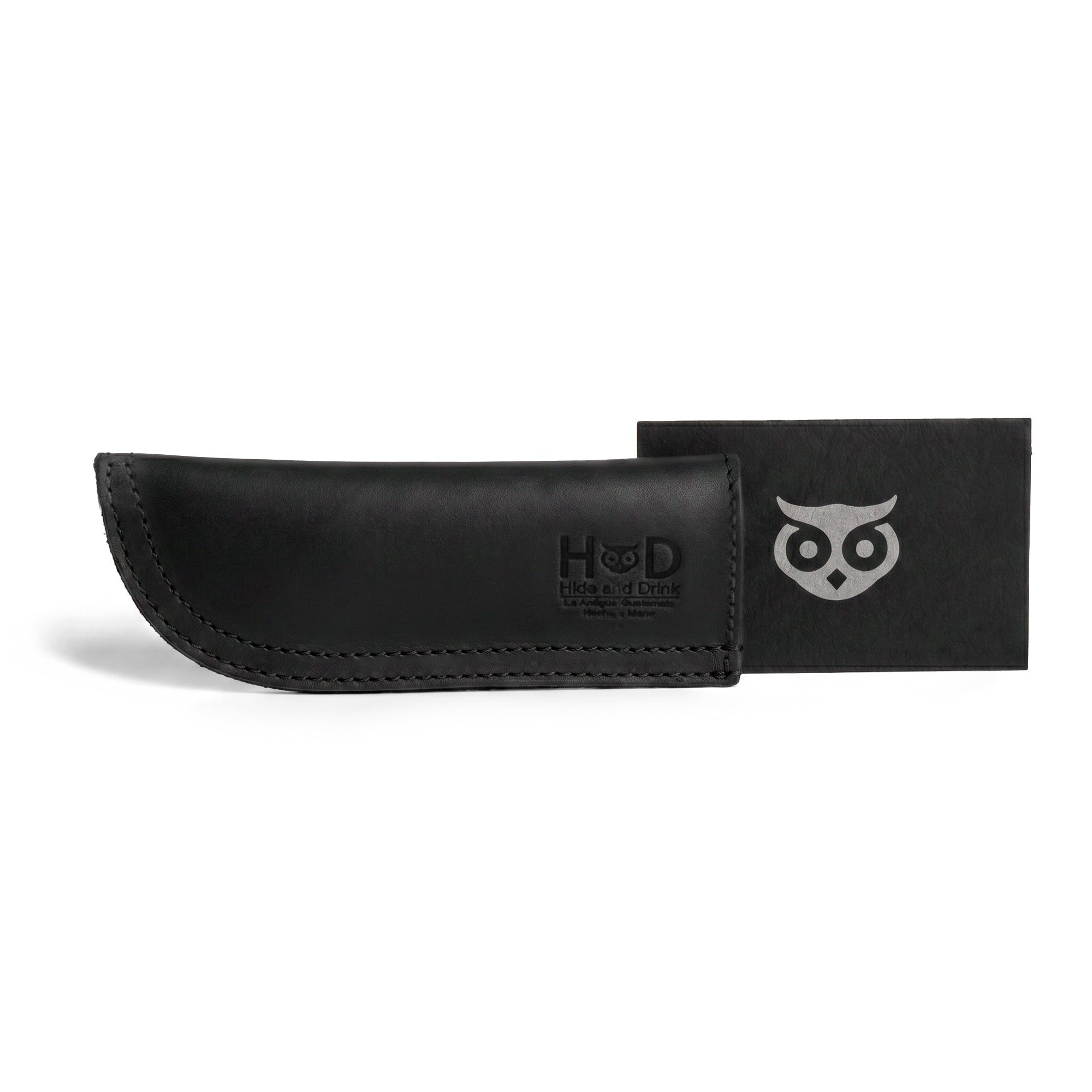 Hide & Drink Cast Iron Panhandle Cover elegantly presented on a skillet, exemplifying its craftsmanship. This durable hot handle protector is made from full grain leather with double stitching for enhanced durability. Handmade in La Antigua Guatemala & Oaxaca Mexico, it's perfect for every cooking enthusiast.