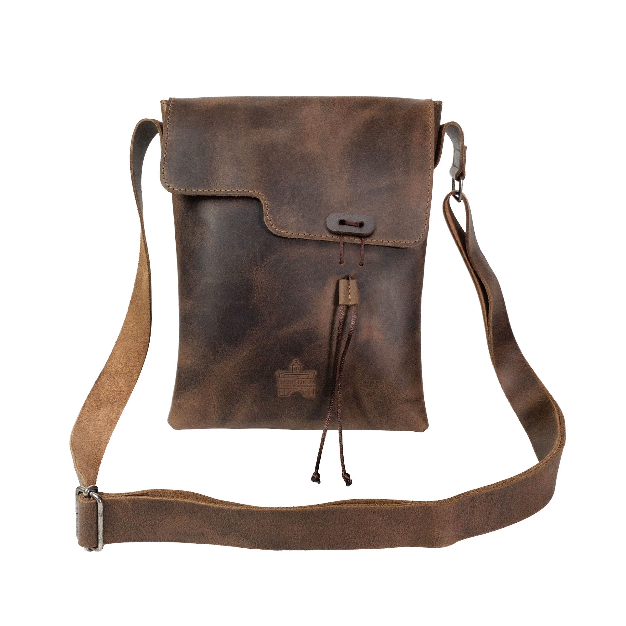 Front view of the La Antigua Treasure Crossbody Bag, emphasizing its rustic appeal and unique craftsmanship. This full grain leather bag features an adjustable shoulder strap, making it a stylish vintage satchel handcrafted in Antigua, Guatemala.