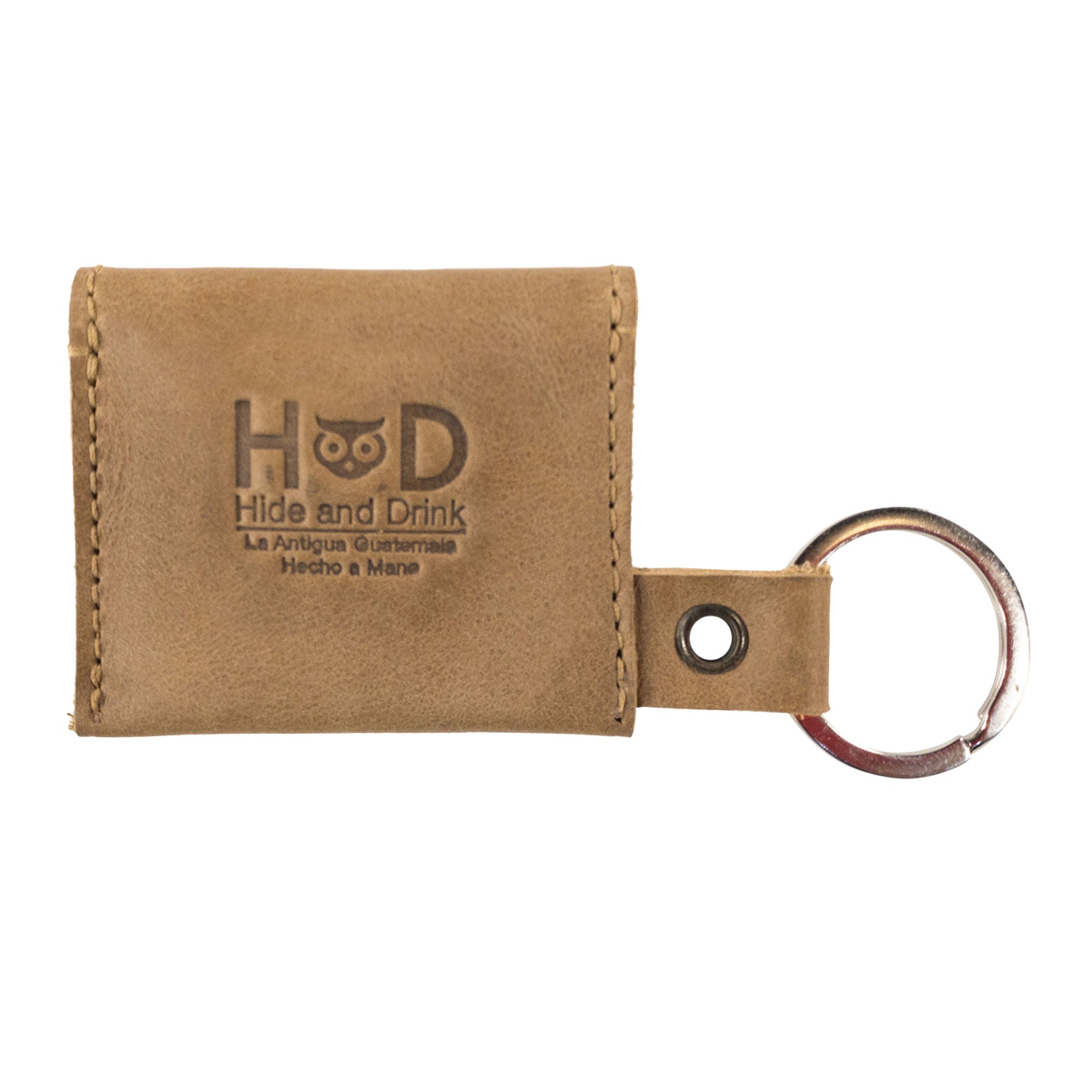 A new version of the Tiny Coin Holder Keychain by Hide & Drink in black leather, highlighting durability and style. This handmade piece emphasizes small batch production and artisan touch in design.