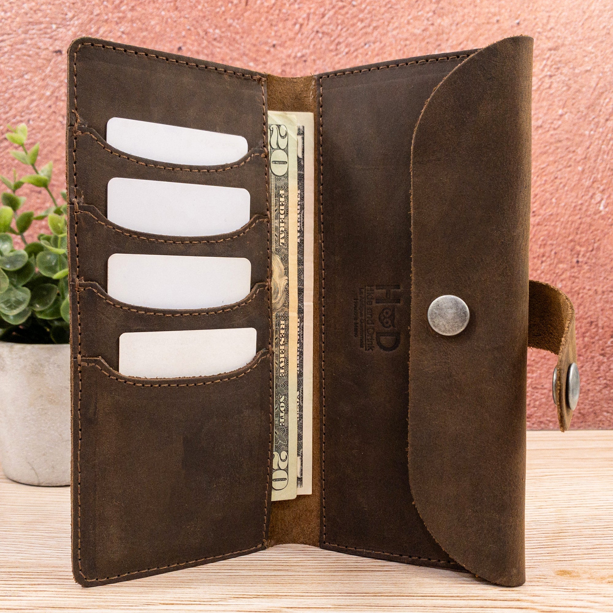 Open view of the Hide & Drink Folio Wallet With Pouch, featuring organized slots for up to 4 cards and space for bills. Made from full grain leather, this handmade wallet is a perfect travel companion, combining functionality with artisan craftsmanship from La Antigua Guatemala & Oaxaca Mexico.