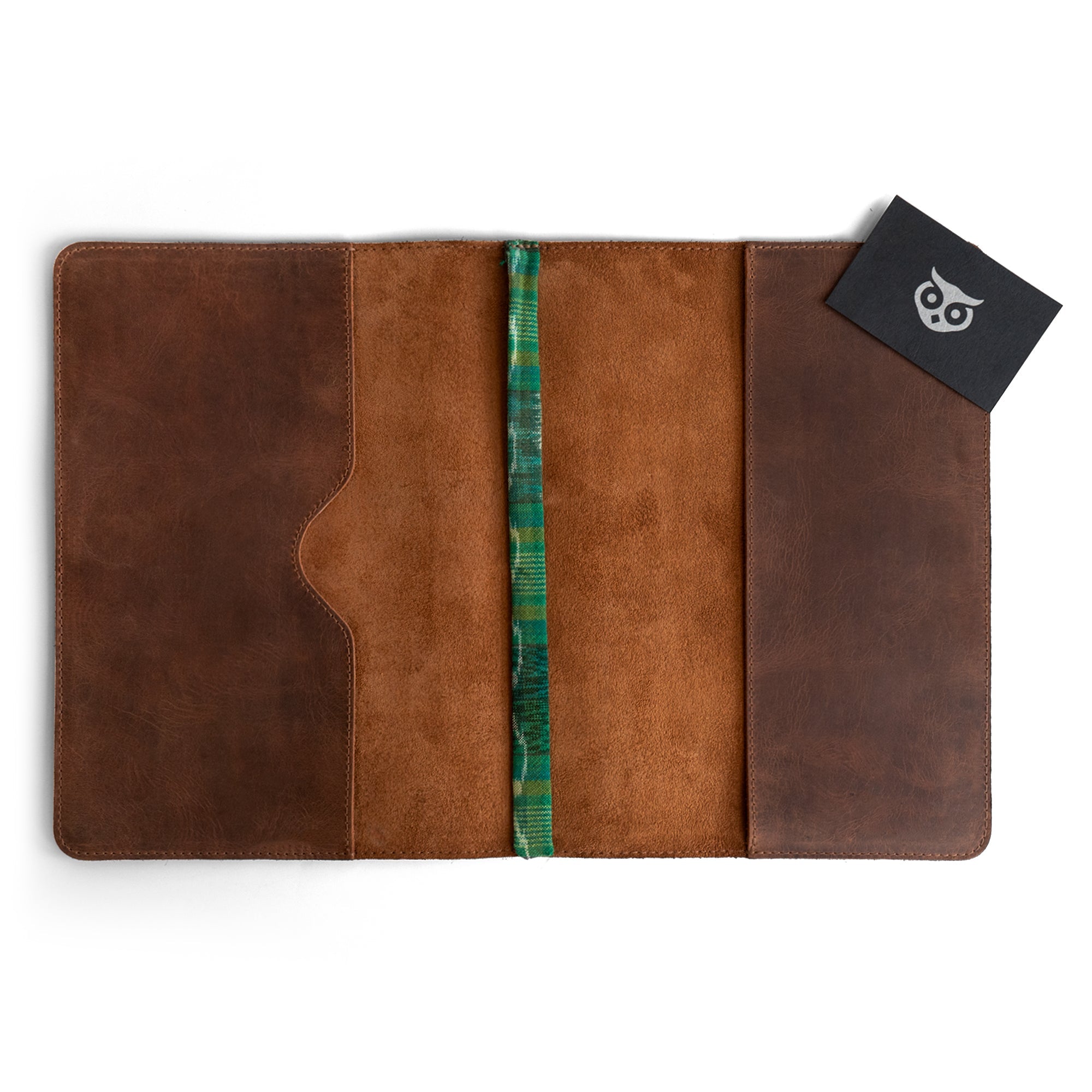 Interior of the Full Grain Leather Journal Cover for Moleskine Cahier XL (7.5 x 9.75 in.) by Hide & Drink, showcasing a neatly organized space for notes and ideas. This leather case offers a handcrafted experience that aligns with those who value quality, taking pride in small batch production labor from Guatemala.