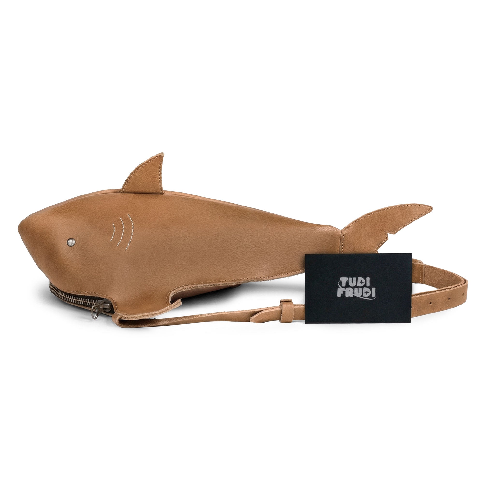 Shark-Shaped Shoulder Bag by Tudi Frudi displayed with branding, showcasing its distinctive design and artisan craftsmanship, including features like an adjustable strap and small batch production using premium Full Grain Leather.