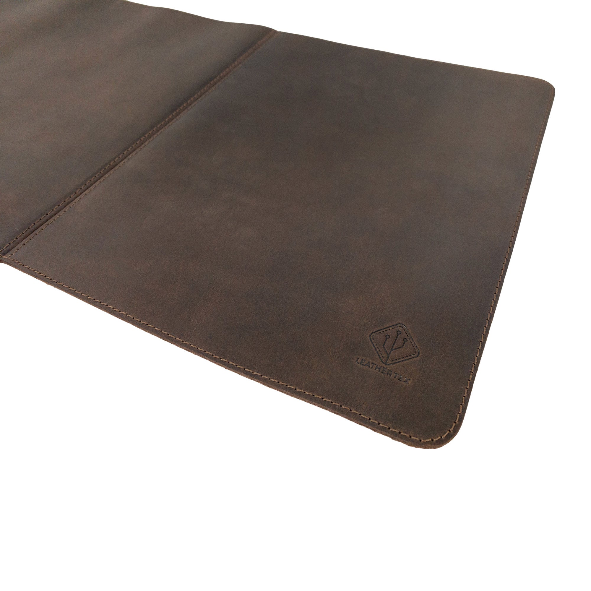 Detail shot of the 34 Inch Long Desk Pad for Keyboard, Mouse, and Cellphone by LeatherTex, emphasizing the rich texture of the full grain leather. This handmade desk accessory highlights the small batch production process and features hand cut and hand sewn details, showcasing the artisan's work from La Antigua Guatemala & Oaxaca Mexico.