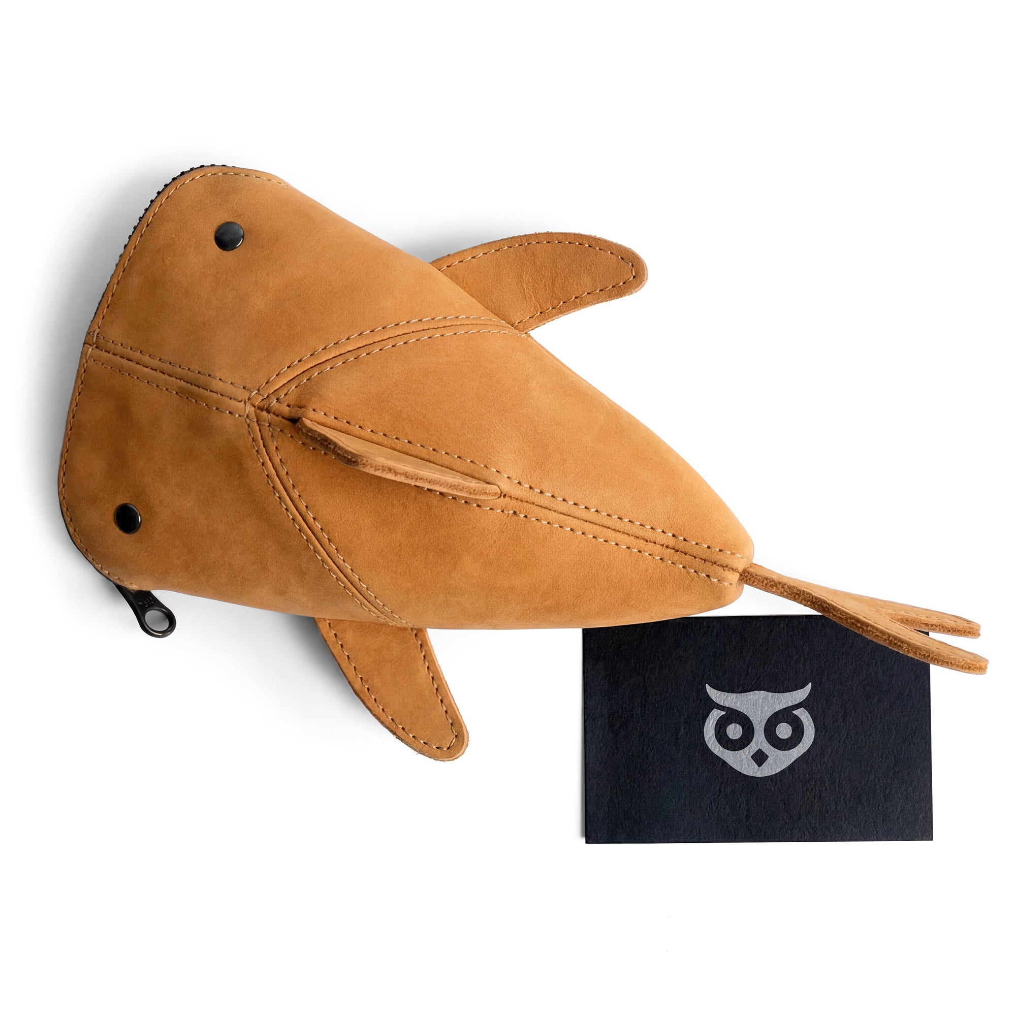 An overhead view of the Hide & Drink Leather Shark Pouch next to a branding card, illustrating the handmade quality of this pouch. Ideal as a versatile wallet or makeup bag, it's crafted from full grain leather in small batches by artisans in La Antigua Guatemala and Oaxaca Mexico.