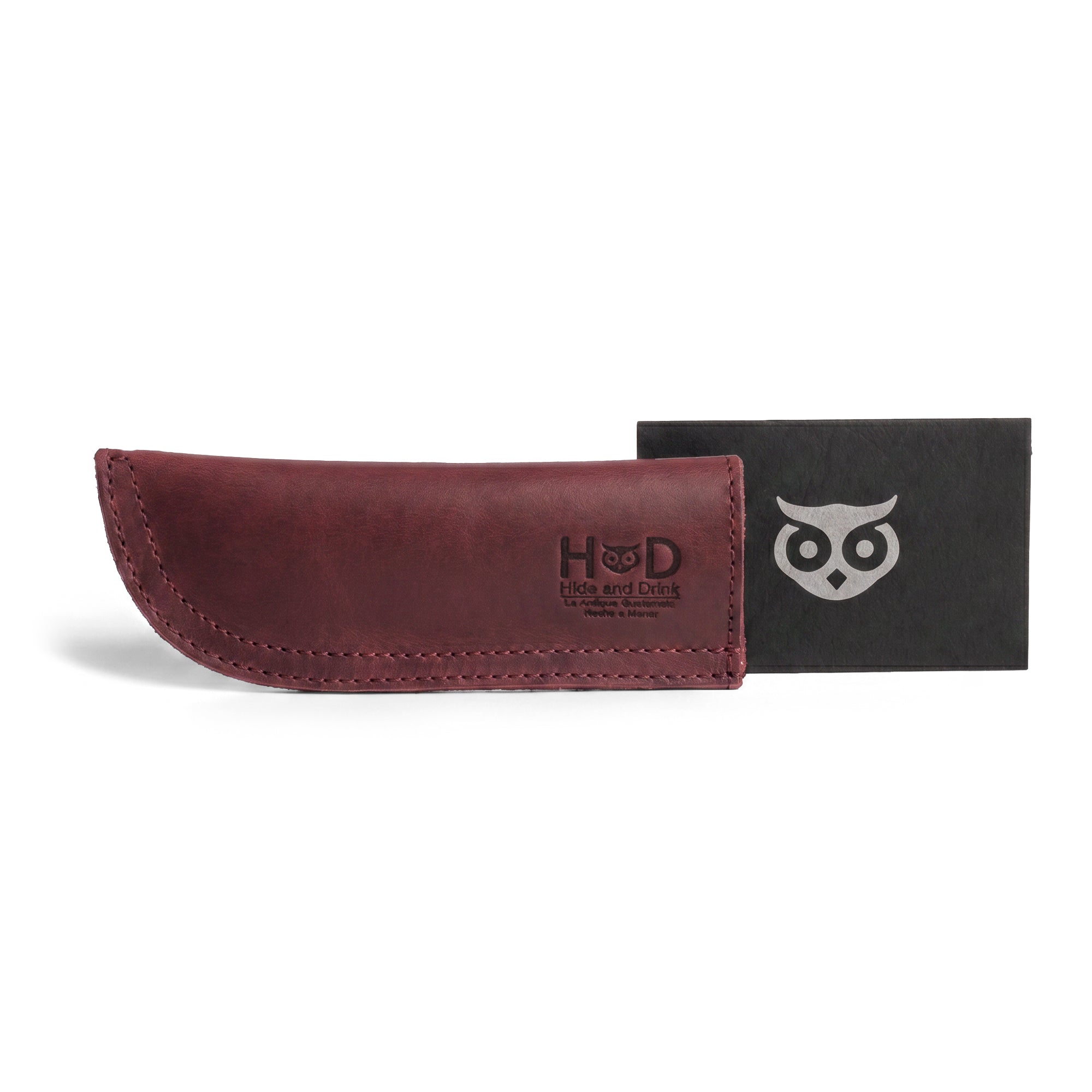 Hide & Drink Cast Iron Panhandle Cover displayed artistically on cookware, showcasing its unique design. This artisan hot handle protector is made from full grain leather and features double stitched durability. Handmade in La Antigua Guatemala & Oaxaca Mexico, it’s perfect for enhancing any kitchen's aesthetic.