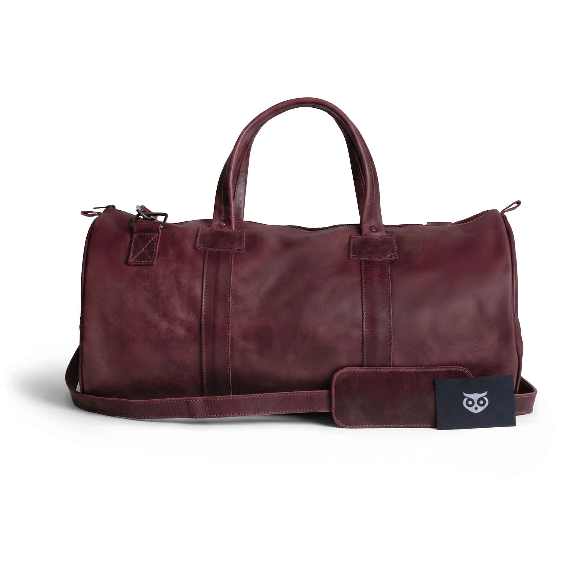 Classic Duffle Bag by Hide & Drink in vibrant pink, featuring a stylish design with a zipper closure and adjustable strap. The Full Grain Leather Classic Duffle Bag is perfect as a Messenger Bag for travel, handmade by artisans in La Antigua Guatemala & Oaxaca Mexico.