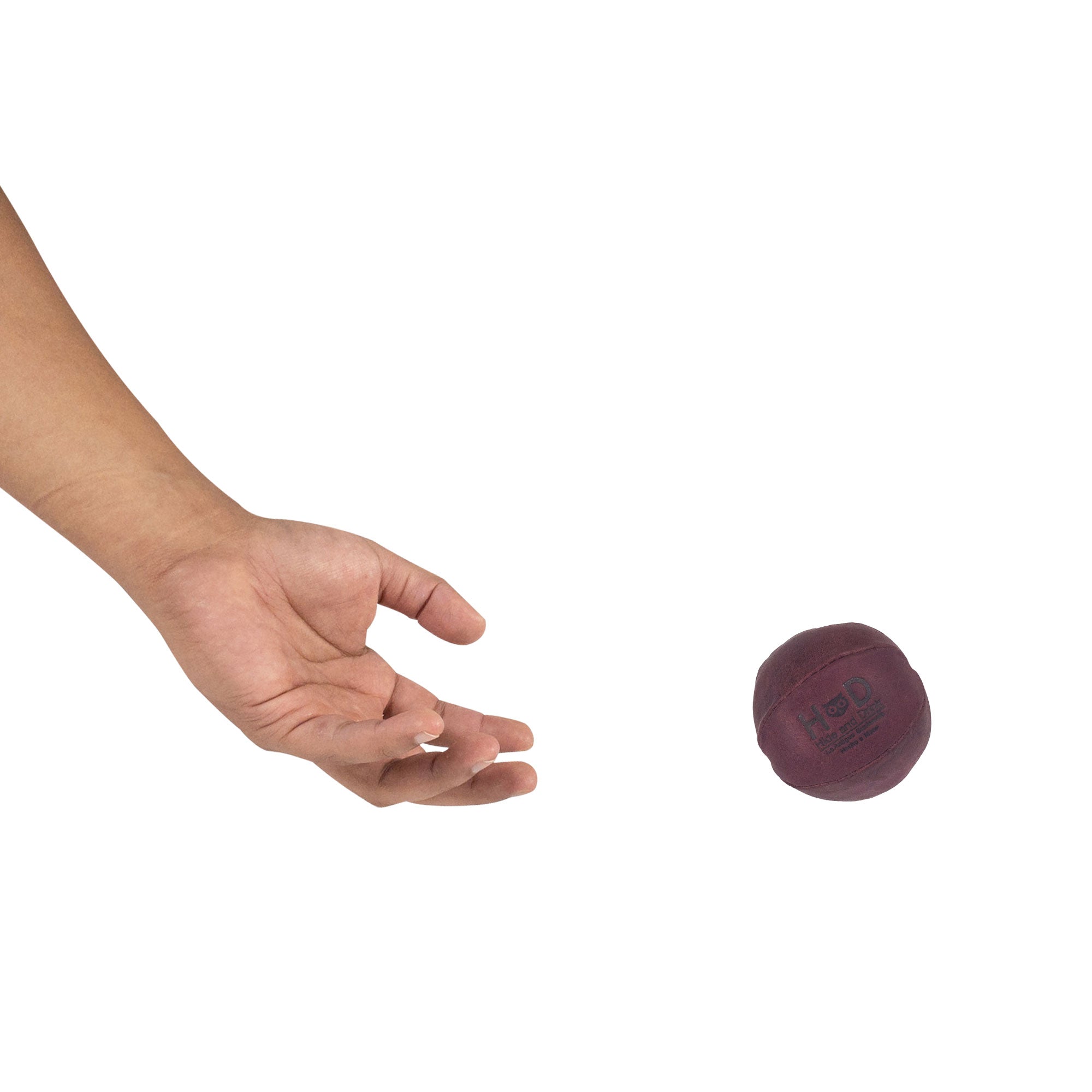 Hide & Drink maroon Stress Ball released into the air, expertly designed to relieve fidgeting and anxiety. This squishy tension accessory features classic style and artisan craftsmanship from La Antigua Guatemala.