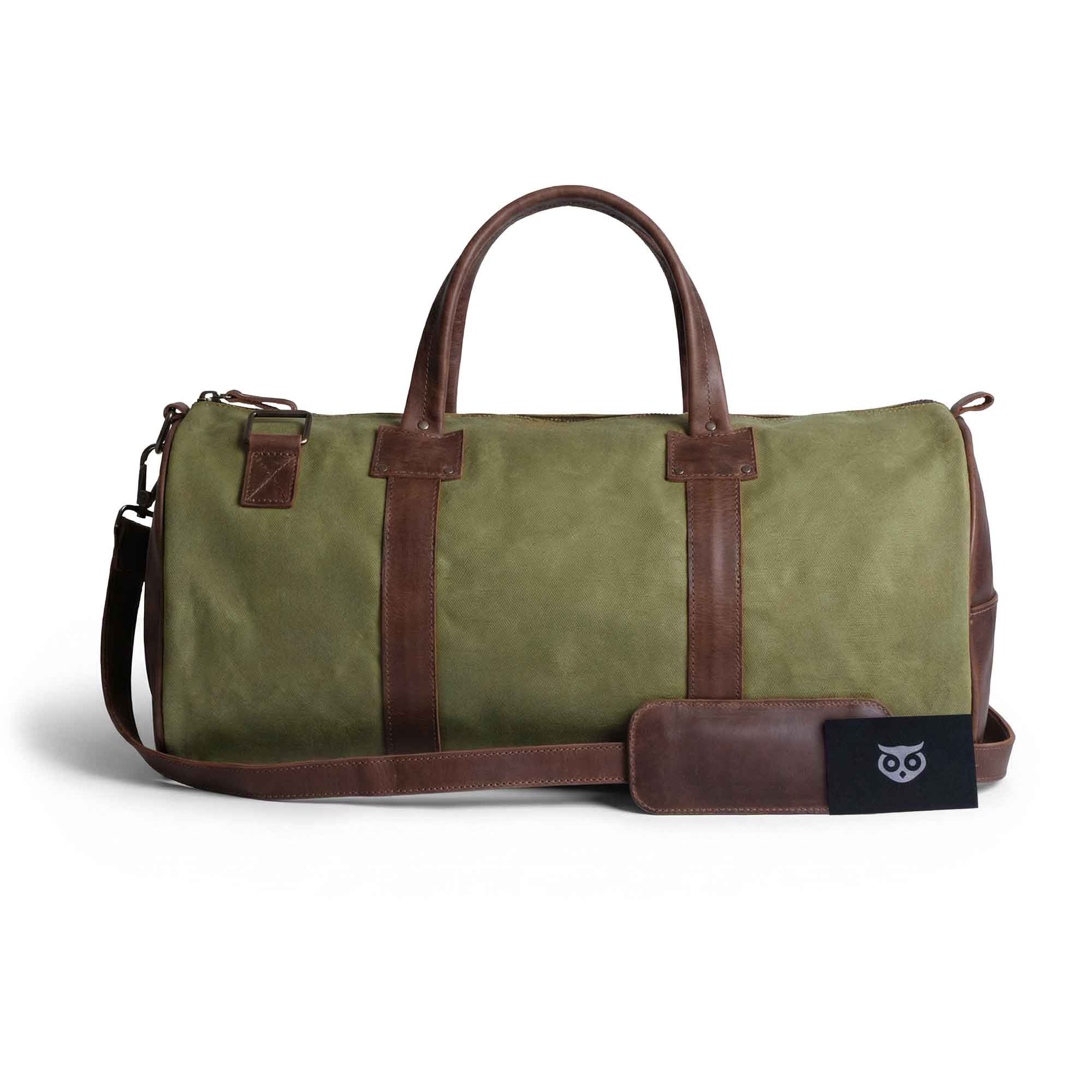 Classic Duffle Bag by Hide & Drink in green fabric, featuring a Full Grain Leather bottom, adjustable strap, and zipper closure. A perfect Messenger Bag for travel needs, this stylish crossbody bag is crafted by artisans in La Antigua Guatemala & Oaxaca Mexico.