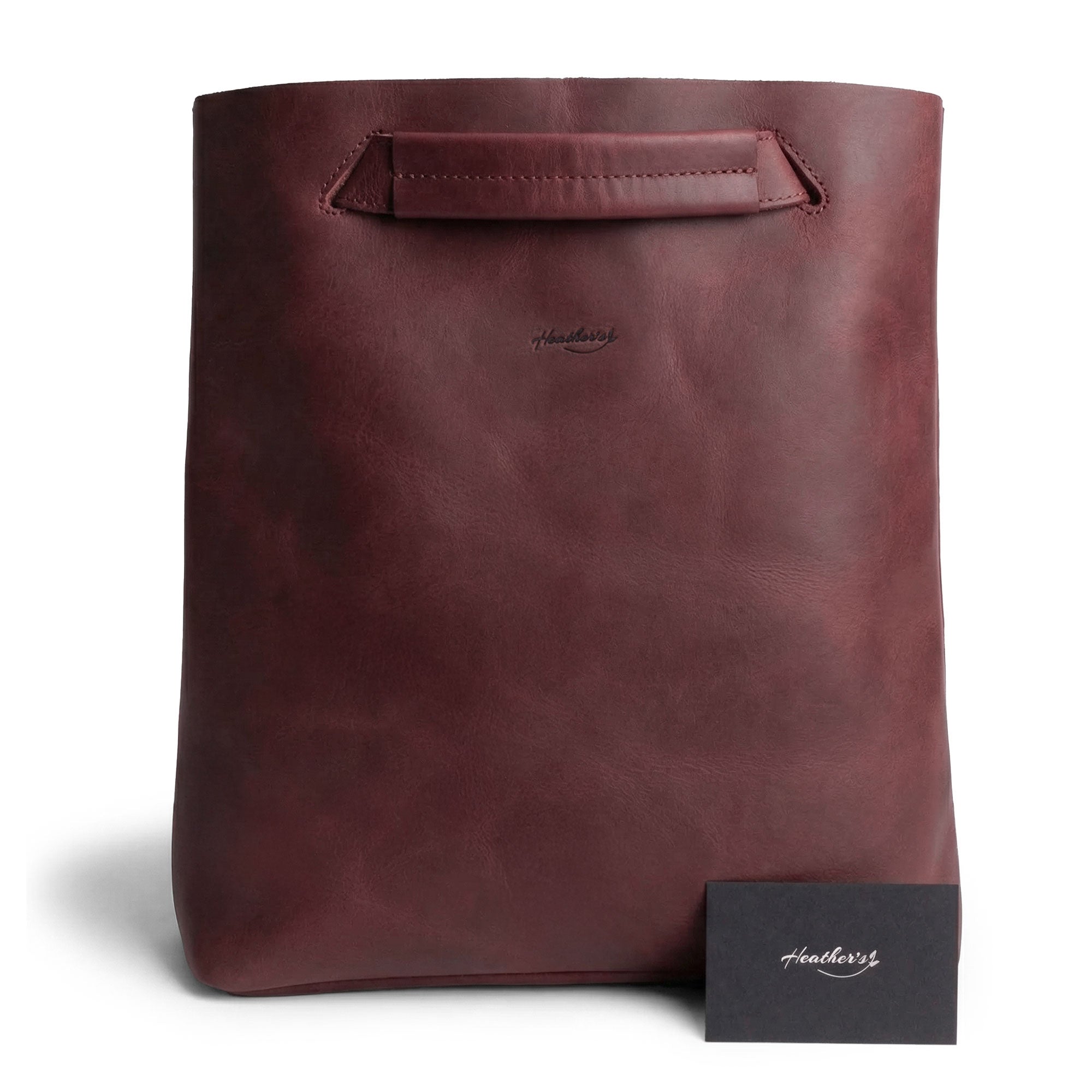 Front view of Heather's Convertible Backpack to Shoulder Bag, highlighting its sophisticated maroon finish and unique handle. This spacious crossbody for women is constructed from Full Grain Leather, embodying the essence of small batch production and artisan expertise through hand cut and hand sewn techniques. Handmade in La Antigua Guatemala & Oaxaca Mexico.