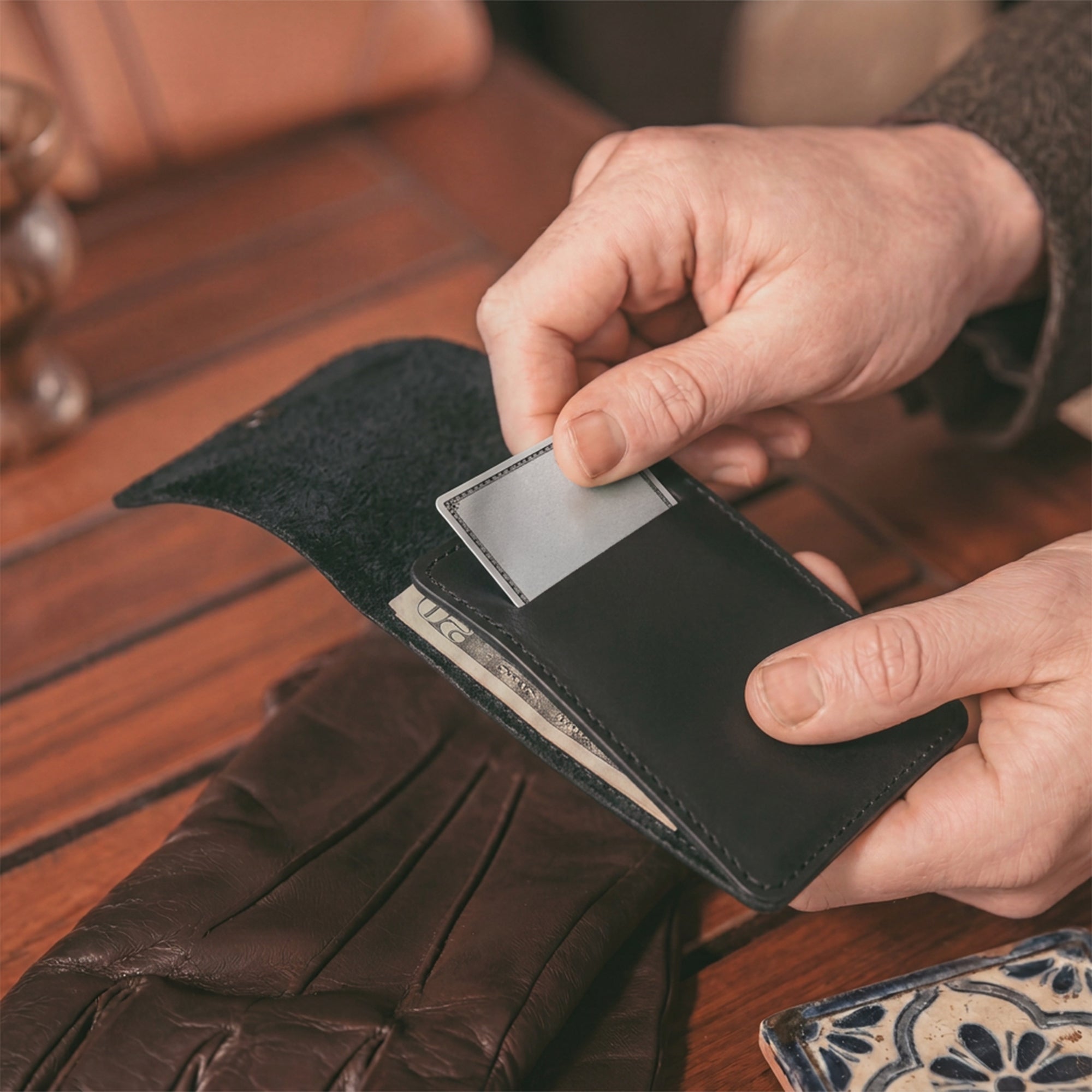 Vertical Wallet by Hide & Drink styled with business cards, showcasing versatility and elegance. This Vertical Front Pocket Wallet with Card Slot ensures compact storage for bills and cards, crafted from full grain leather emphasizing small batch artistry with hand cut, hand sewn details and fire branded signs of authenticity. Handmade in La Antigua Guatemala & Oaxaca Mexico.