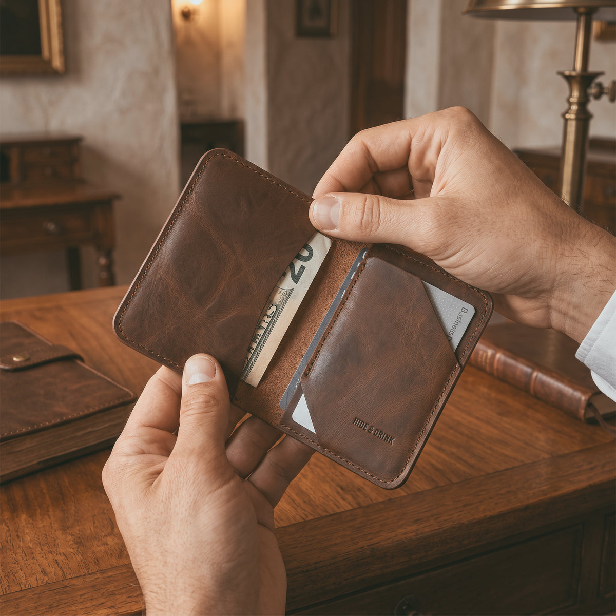 Bi-Fold Card Wallet Diagonal by Hide & Drink with cards inserted, illustrating its capacity to hold up to 5 cards plus folded bills, along with stylish full grain leather craftsmanship, a true accessory for anyone.