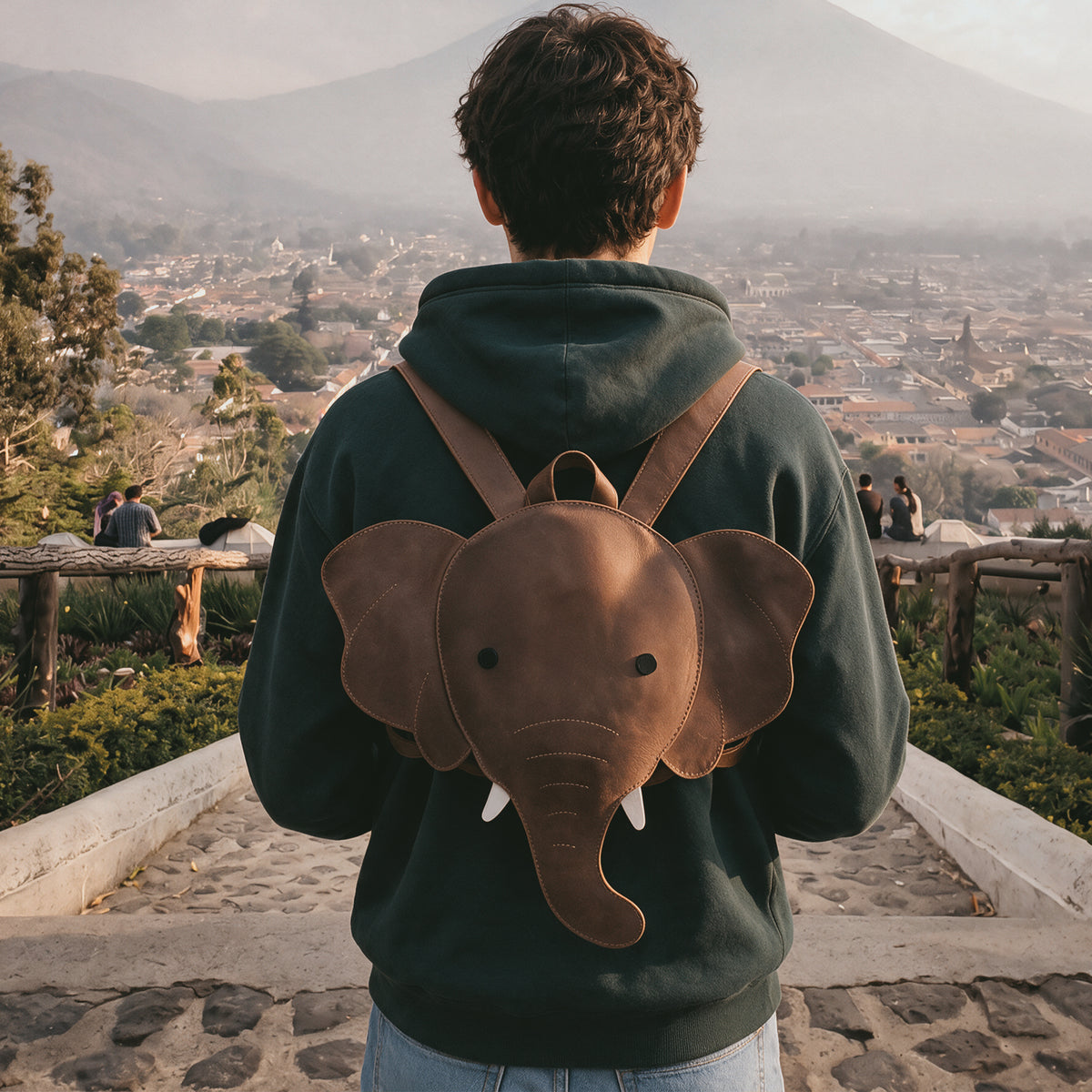 Unique Elephant-Shaped Backpack by Hide & Play, showcasing a playful elephant silhouette. This versatile Messenger Bag is crafted from Full Grain Leather, perfect as a Travel Bag for Men and Women. StockyardX emphasizes artisan quality through handmade processes in La Antigua Guatemala, ensuring durability and style.