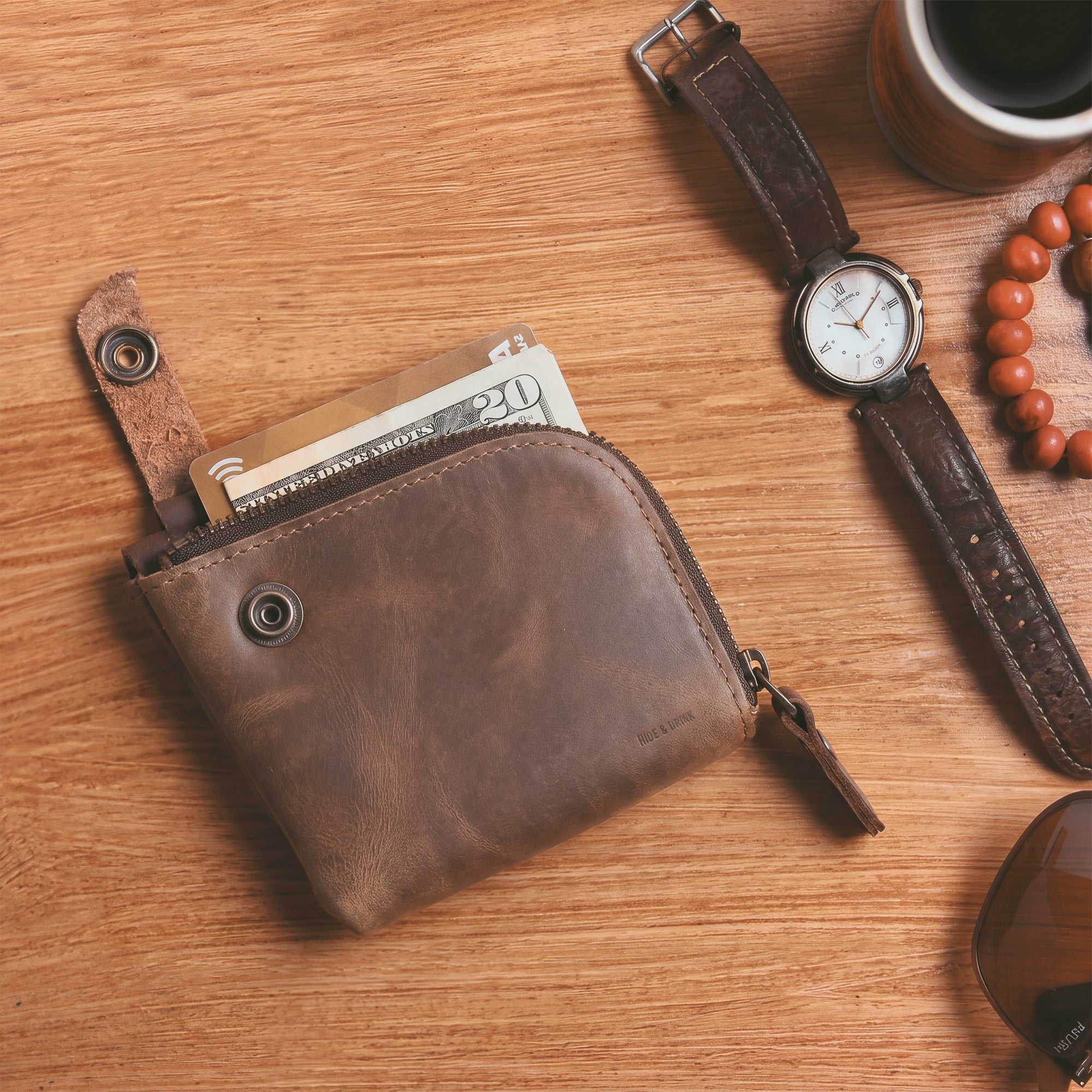 Lion's Mane Zippered Wallet by Hide & Drink, a compact zippered wallet made of full grain leather, ideal for storing cards and cash. Perfect travel essentials and a stylish mini pouch organizer, crafted with attention to detail in La Antigua Guatemala.