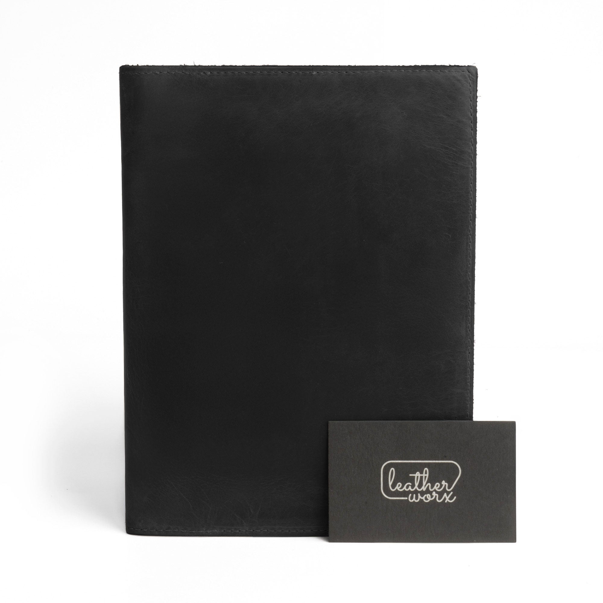 Front view of the black Leather Worx Notepad Case 5 x 8 In. with a branding detail, paired with a card showcasing its artisan craftsmanship. Notepad Cover (5 x 8 In. Notepad Not Included) Sturdy, Durable Material Perfect for Storing Journal, Full Grain Leather, StockyardX, Small Batch Production, Hand Cut, Hand Sewn, Fire Branded, Artisan, Handmade in La Antigua Guatemala & Oaxaca Mexico.