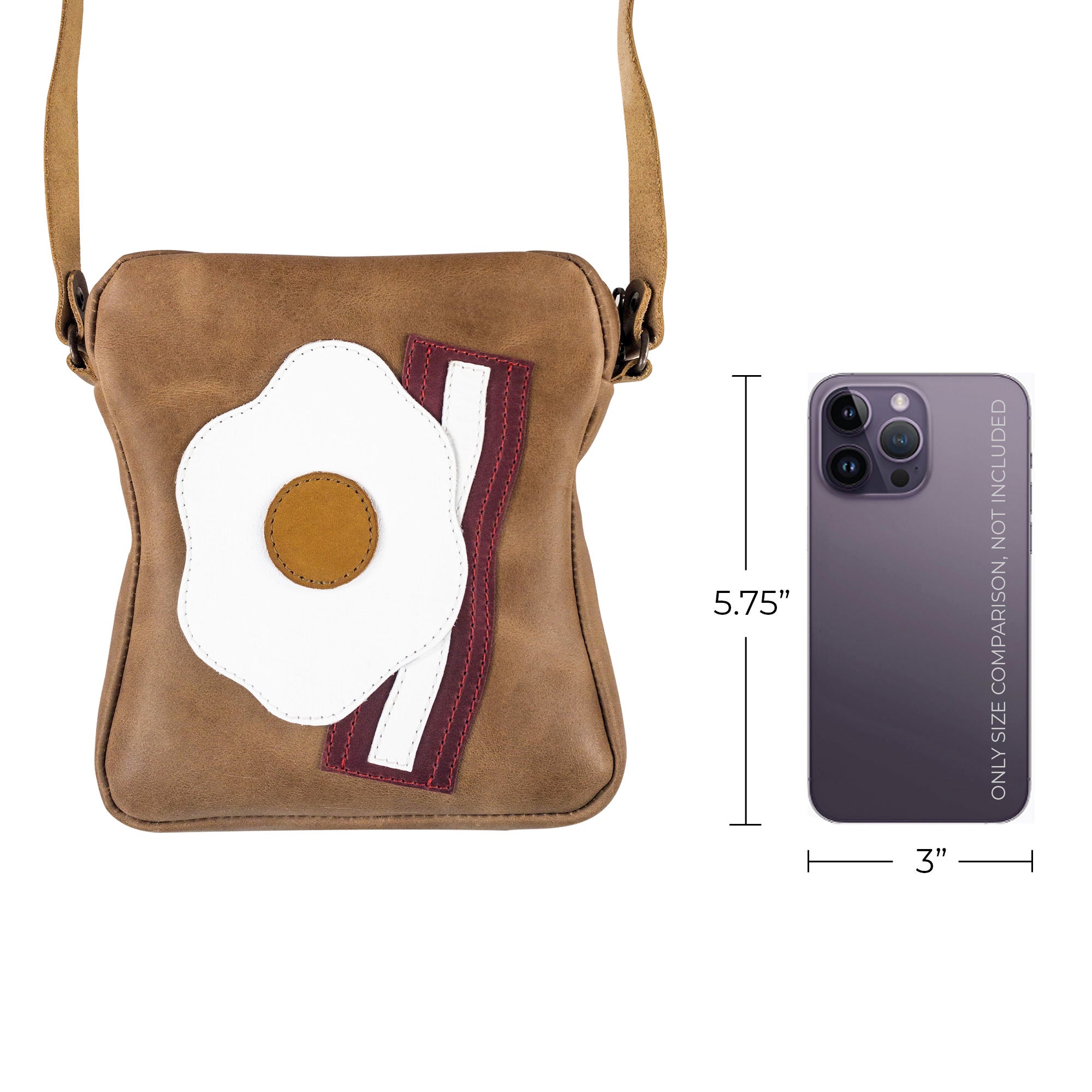 The Egg and Bacon Sandwich-Shaped Shoulder Bag by Tudi Frudi shown with a phone for size comparison, highlighting its small yet functional design. Perfect as a Handbag, Crossbody Bag, or Messenger Bag, made from Full Grain Leather with Hand Cut and Hand Sewn elements by skilled artisans from La Antigua Guatemala.