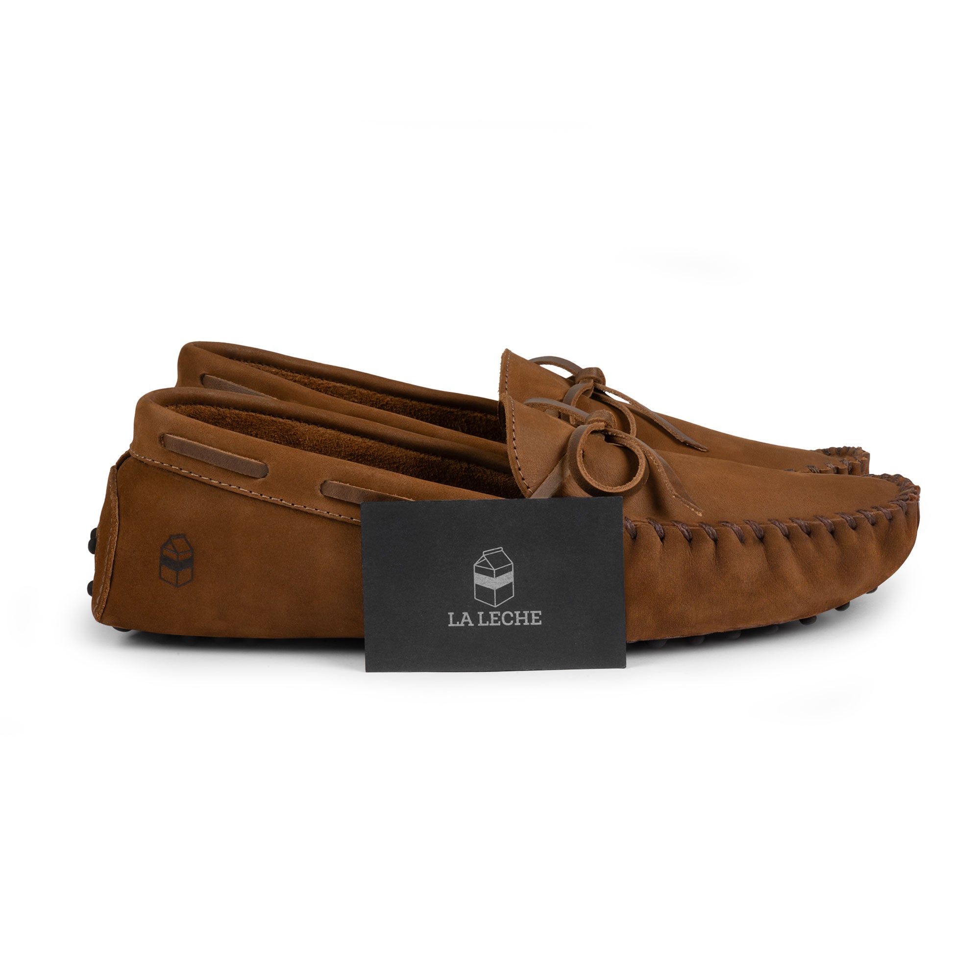 The Roadster Leather Driving Moccasins presented with a branded card from La Leche, highlighting the luxurious Full Grain Leather and artisan craftsmanship. Each pair is handmade in La Antigua Guatemala & Oaxaca Mexico.