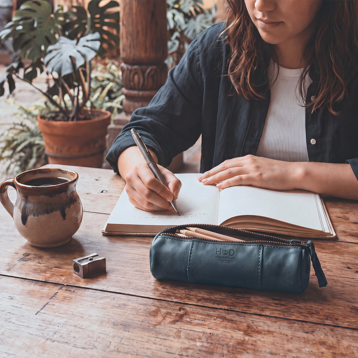 Side view of the Utility Cylinder Case by Hide & Drink featuring a strong zipper for secure storage. This elegant, handmade bag is perfect for cables or personal items, emphasizing Full Grain Leather craftsmanship. Cylinder Case, Rustic, Artisan.
