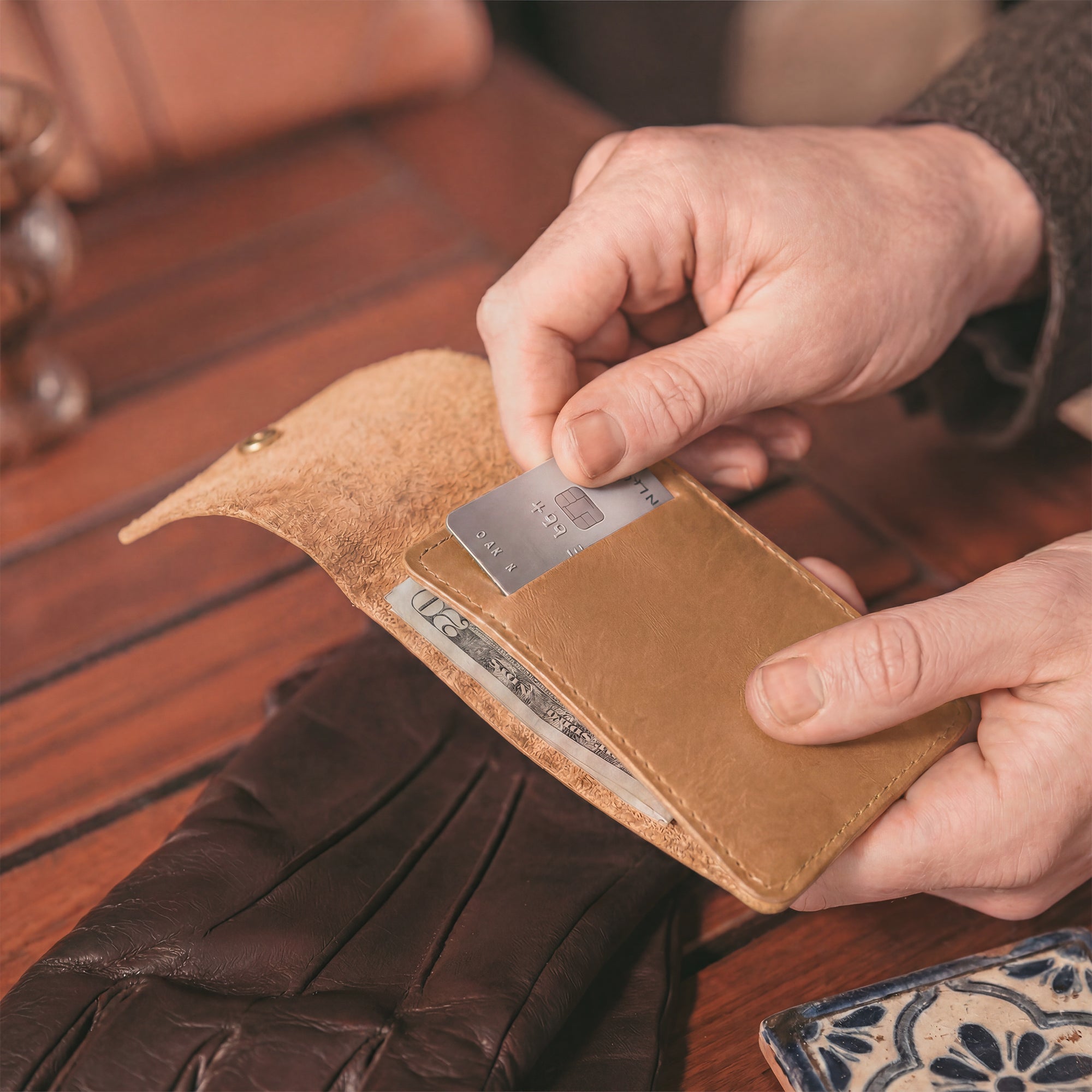 Interior view of the brown Vertical Wallet by Hide & Drink emphasizing storage for bills and cards. This Vertical Front Pocket Wallet with Card Slot merges style and compactness, crafted of strong full grain leather through small batch production, highlighting hand cut and hand sewn finishes with fire branding for uniqueness. Handmade in La Antigua Guatemala & Oaxaca Mexico.