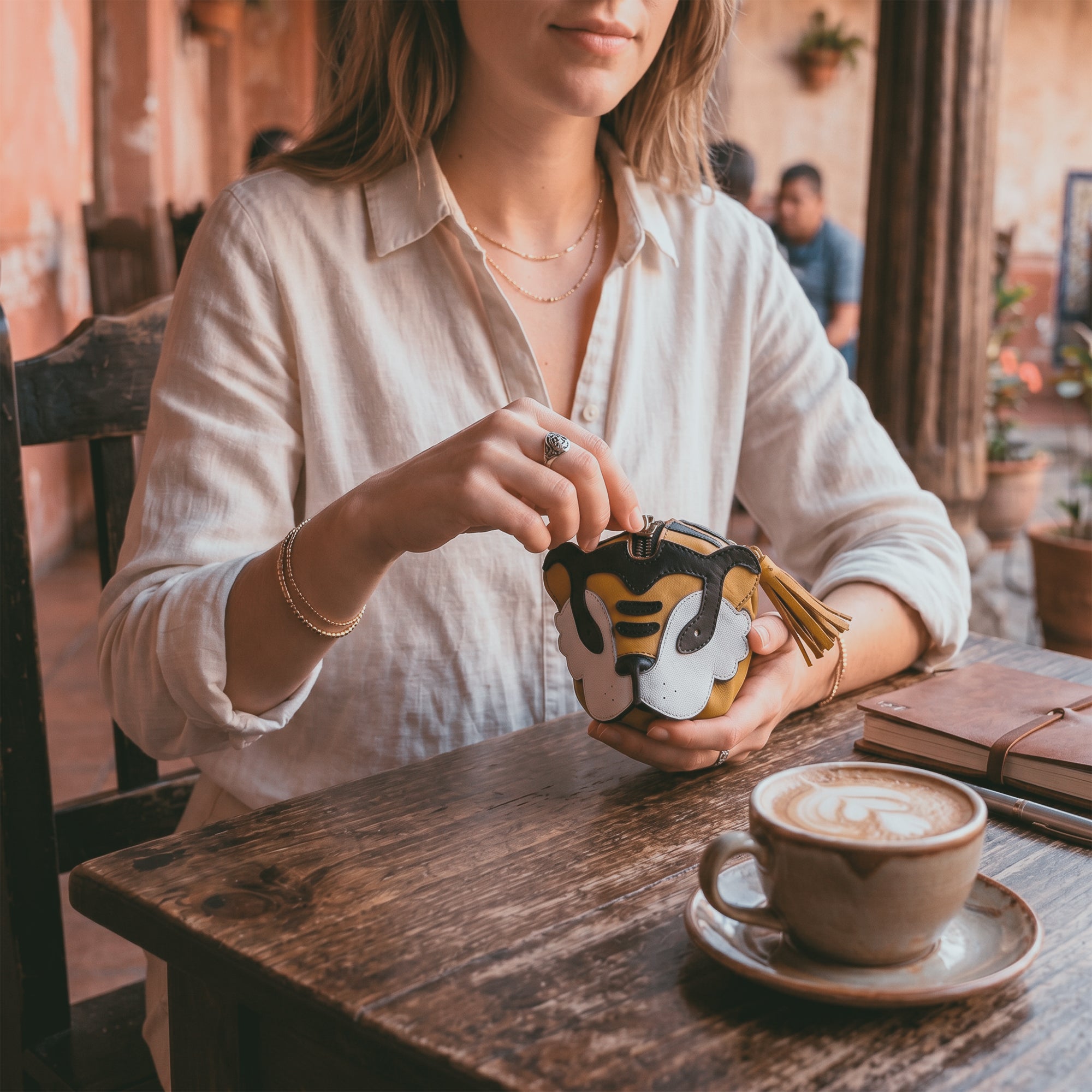 Lifestyle image featuring the Tiger Leather Pouch from Tudi Frudi, depicting its use as a stylish accessory for everyday organization. Perfect as a Leather Coin Purse or Change Bag, made from Full Grain Leather and hand sewn by artisans in La Antigua Guatemala & Oaxaca Mexico.