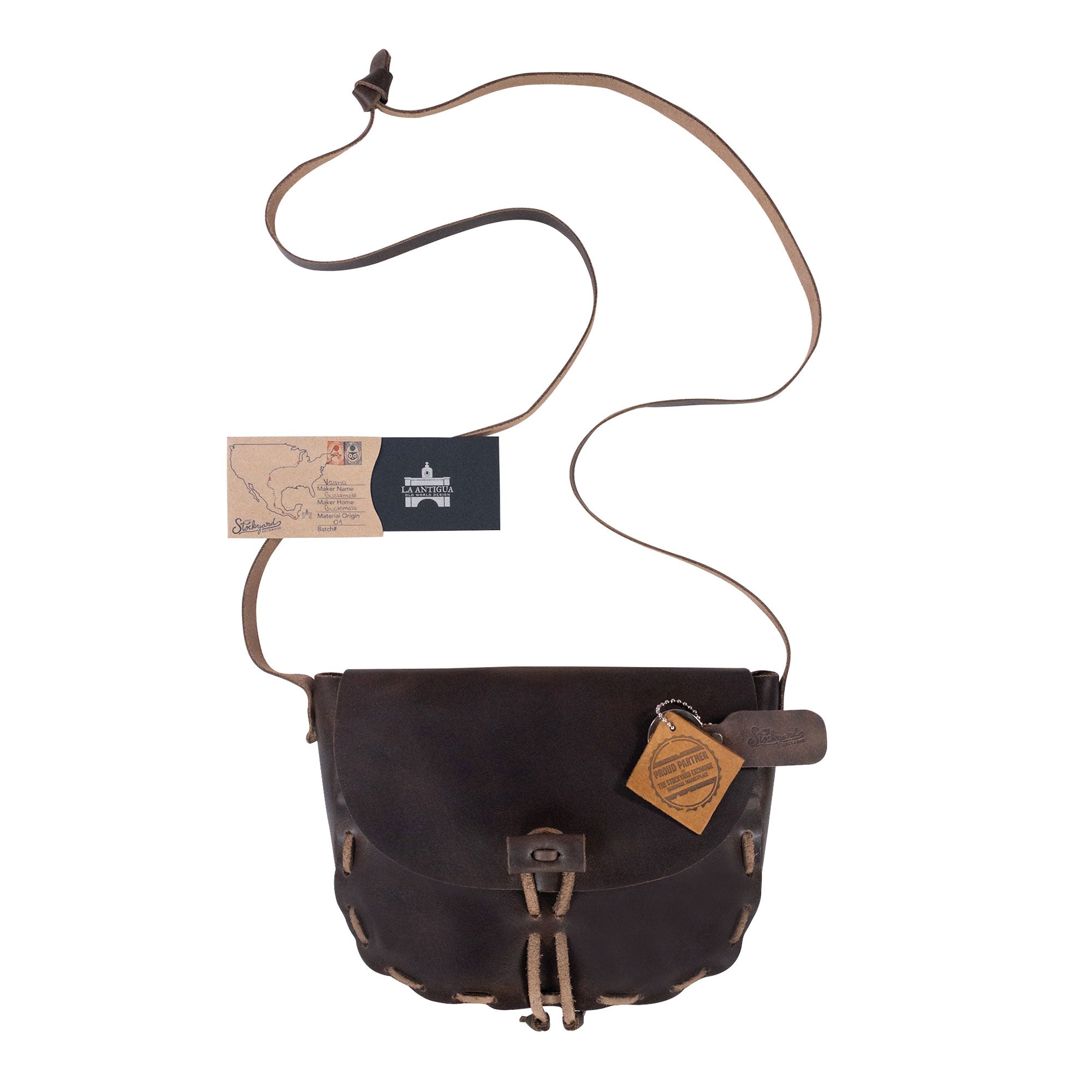 Medieval Style Shoulder Bag from La Antigua presented with accessories. This versatile crossbody bag is ideal for travel and everyday use. Made of Full Grain Leather, it embodies artisanal craftsmanship through hand cut, hand sewn, and fire branded techniques, reflecting the quality of small batch production in La Antigua Guatemala & Oaxaca Mexico.