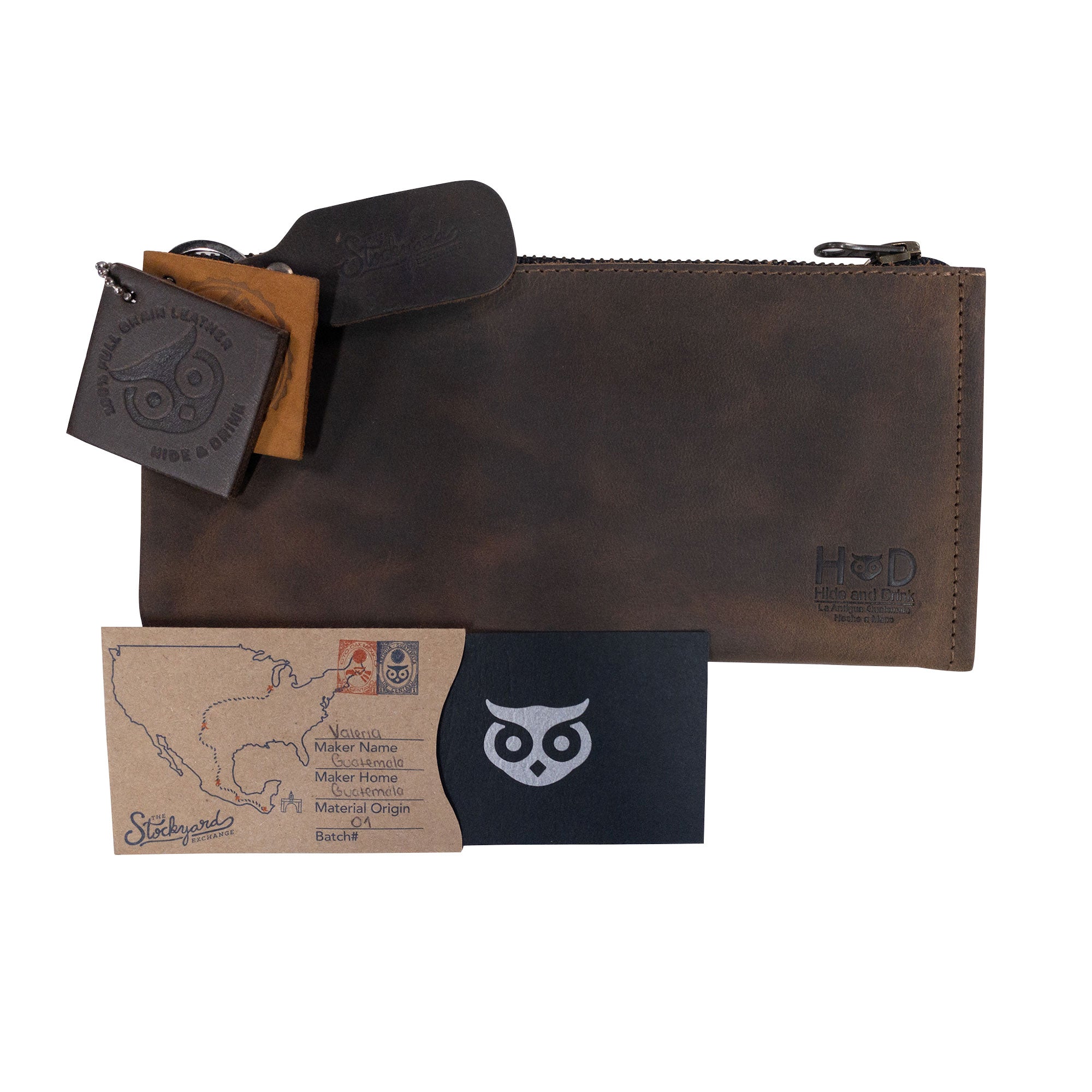 Hide & Drink Zipper Wallet presented with accompanying business cards. This zippered bag is a Rectangular Wallet with Inner Card Slots, crafted from premium Full Grain Leather. This Rustic Card Holder serves as a stylish Travel Accessory showcasing stockyardX’s Artisan skills, demonstrating Small Batch Production, Hand Cut, and Hand Sewn techniques. Handmade in La Antigua Guatemala & Oaxaca Mexico.