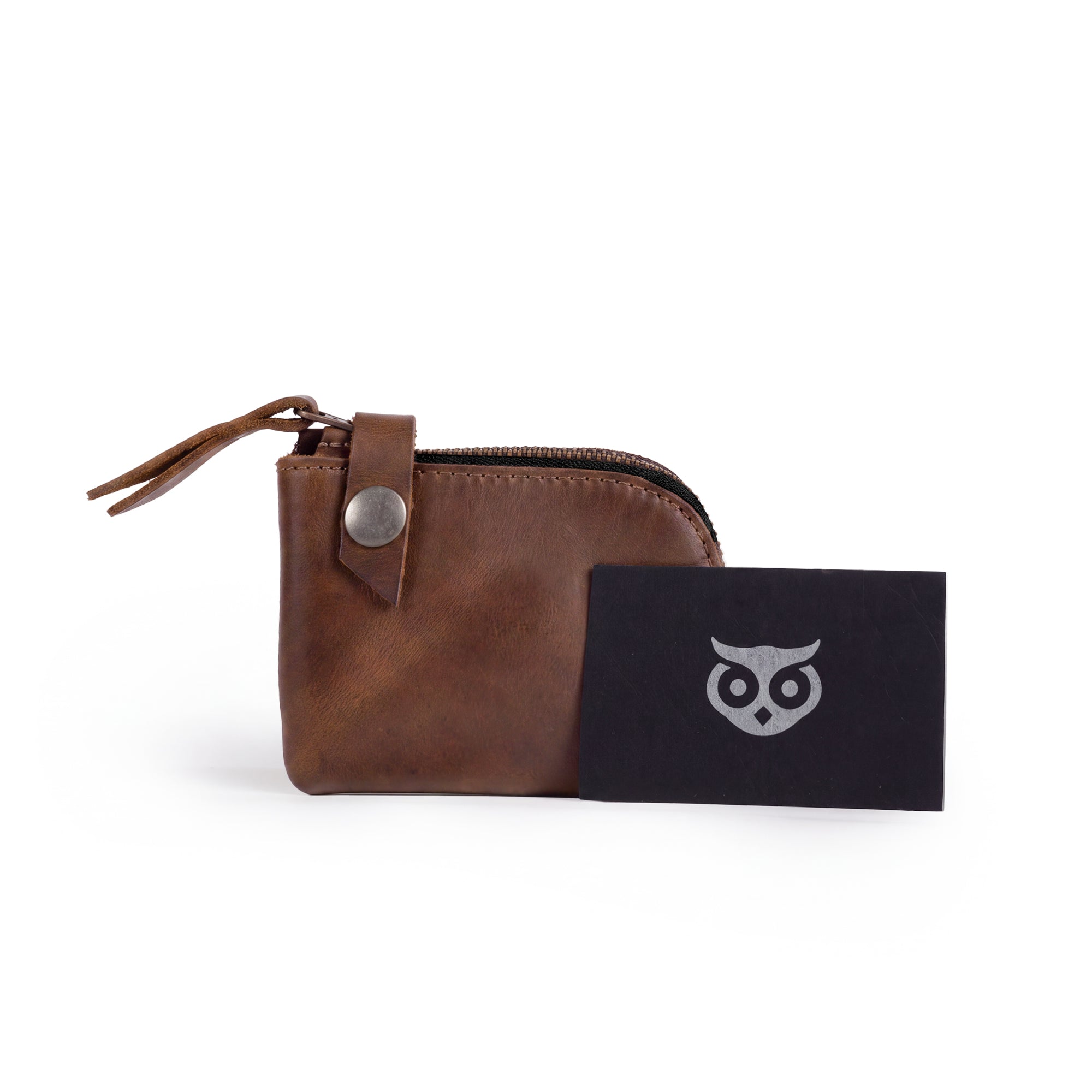 Lion's Mane Zippered Wallet by Hide & Drink with a stylish card and paper label. Crafted from full grain leather, it represents fine artisan quality and is perfect for carrying essentials in a compact format.