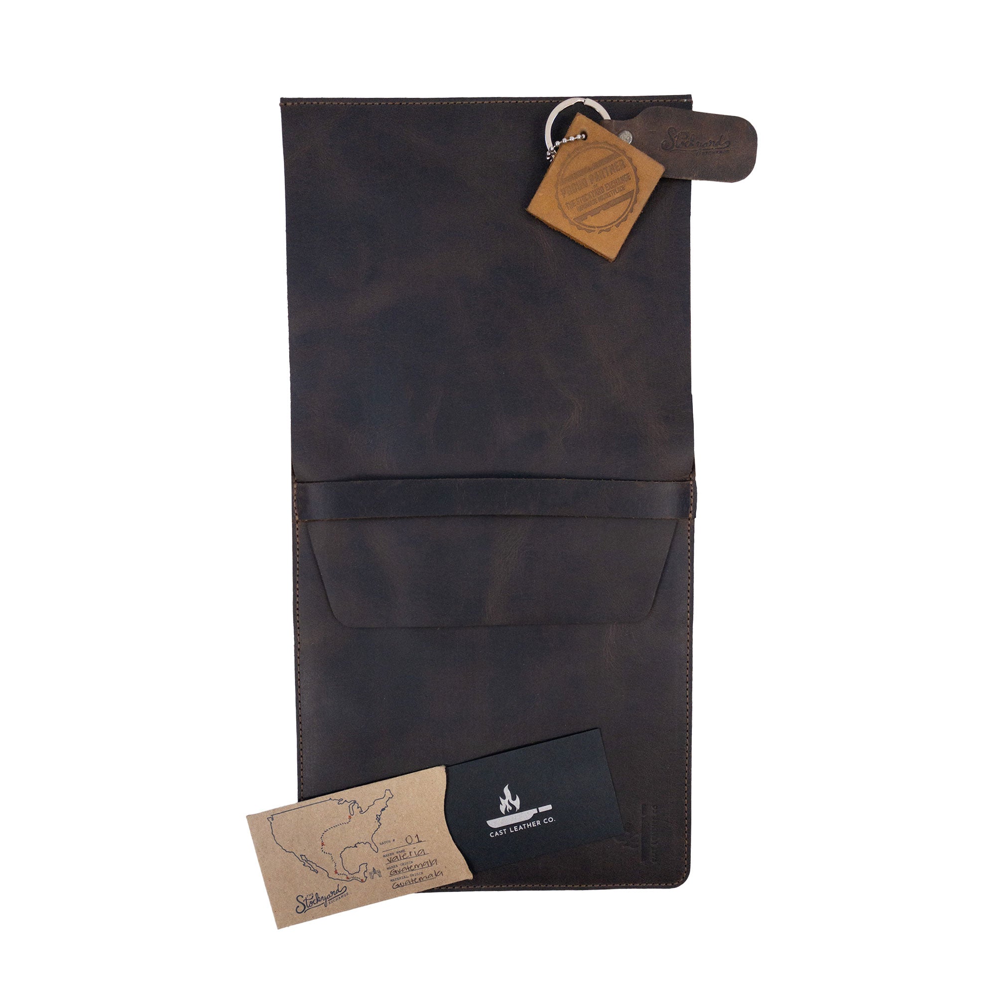 The Knife Case with 3 Slots by Cast Leather Co. displayed with care tags and the artisan's mark. This stylish knife organizer embodies rustic storage for kitchen utensils, crafted from full grain leather with a commitment to small batch production alongside hand-cut, hand-sewn techniques, fire branded for a unique touch, all handmade in La Antigua Guatemala & Oaxaca Mexico.