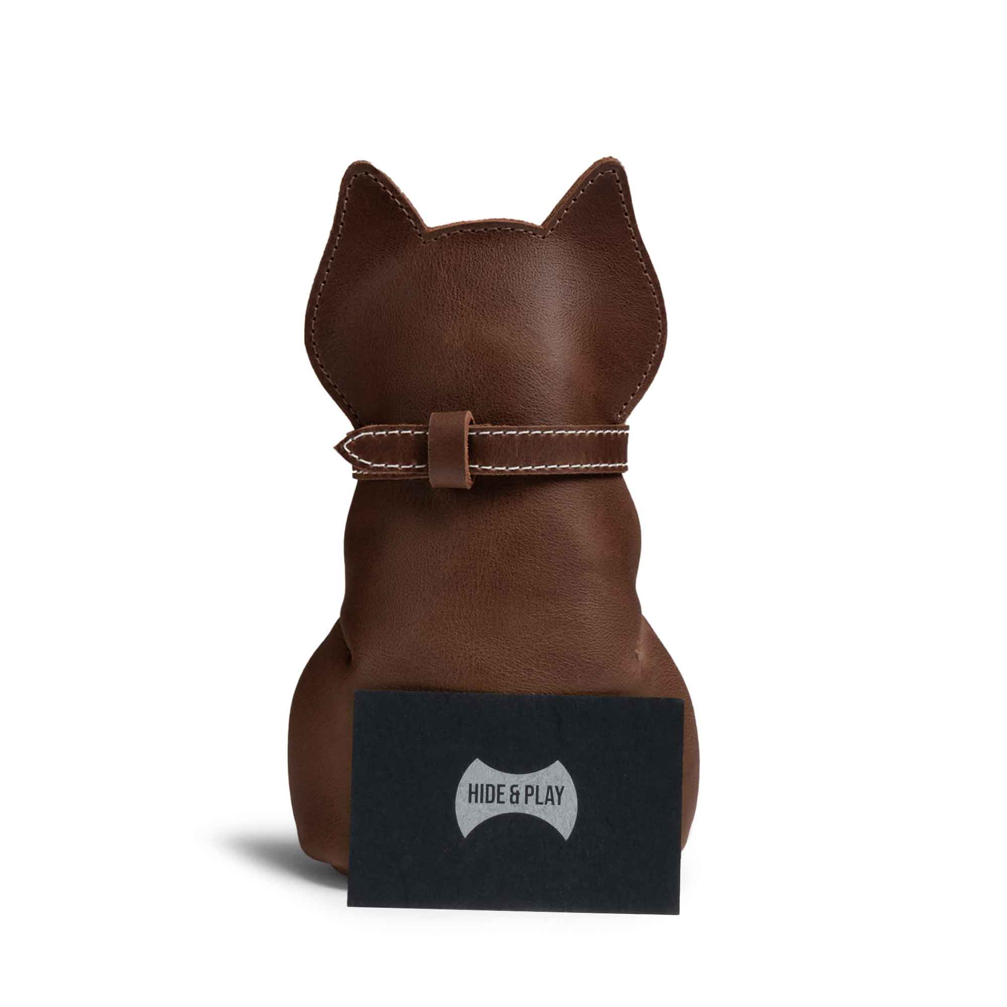 The Hide & Play Kitty Pouch displayed with a branded card. This artisan-crafted Small Coin Pouch, with its Cat-Shaped design, serves as a chic pocket saving box for coins and reflects quality and care in its handmade production.