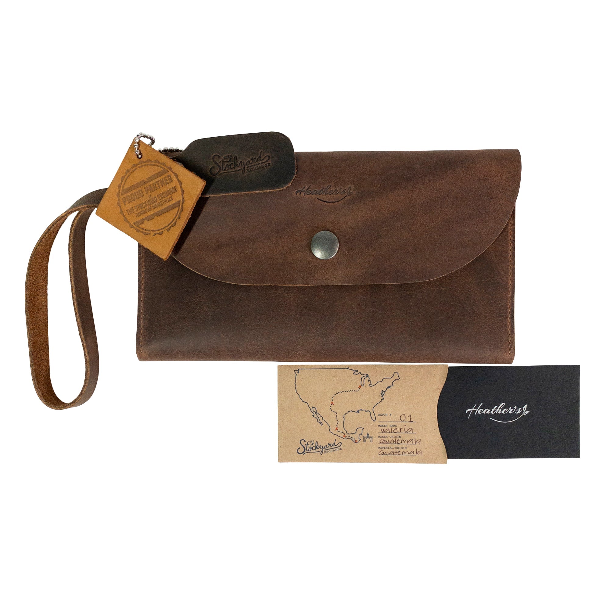 Heather's Wallet with Wristlet displayed with a product tag, emphasizing its quality and craftsmanship. This wallet is made of Full Grain Leather, designed for women, making it a stylish yet practical travel accessory and money organizer. StockyardX, Small Batch Production, Hand Cut, Hand Sewn, Fire Branded, Artisan, Handmade in La Antigua Guatemala & Oaxaca Mexico.