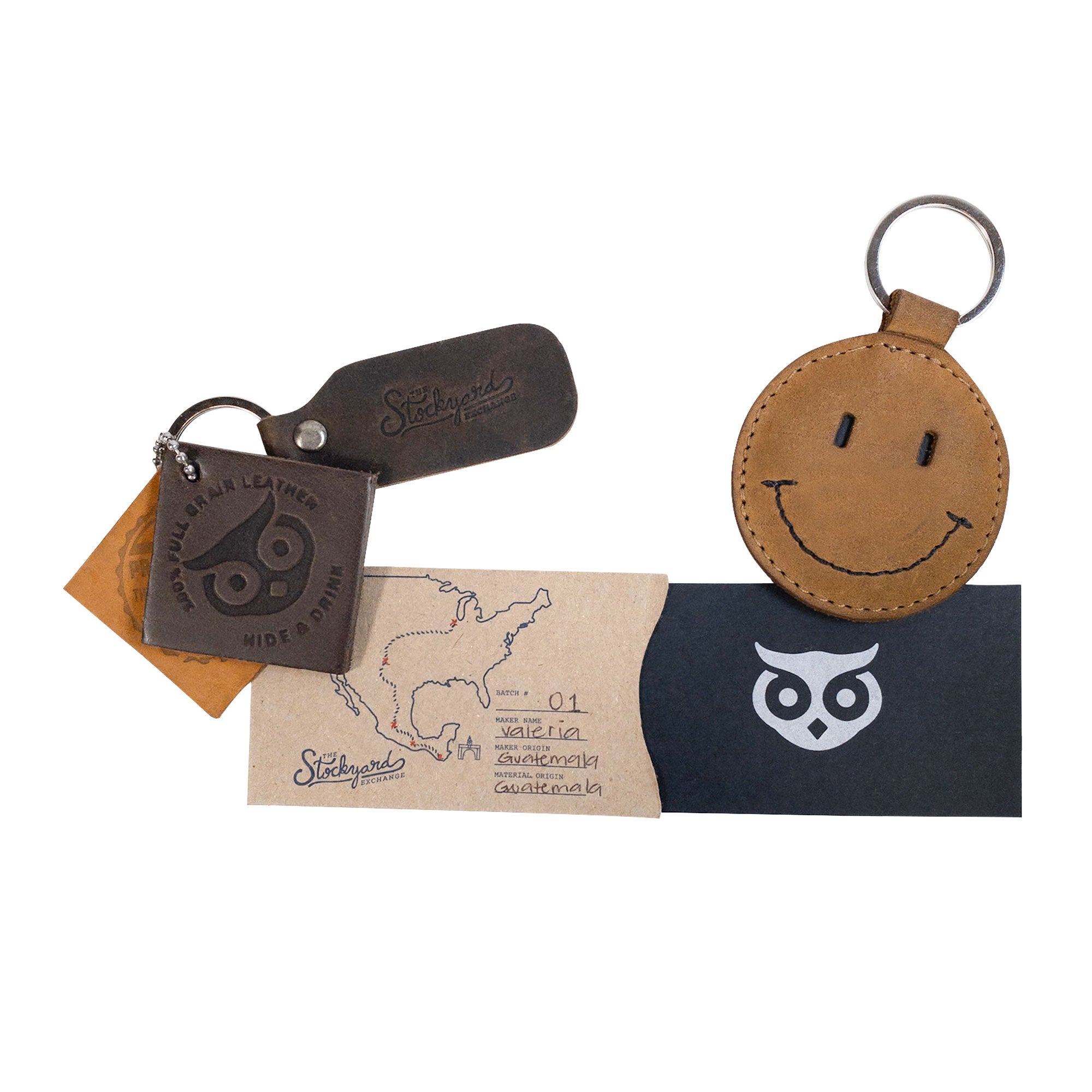 A collection of accessories including the Smiley Face Keychain by Hide & Drink, demonstrating its unique style along with other leather goods. This key ring is handcrafted from Full Grain Leather, showcasing artisan skills perfect for cute gifts and everyday accessories made in Oaxaca Mexico.