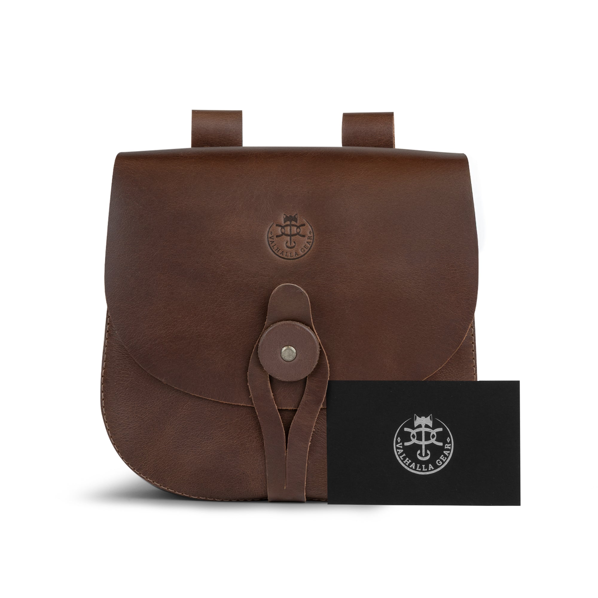 The Forester, Waist Bag by Valhalla Gear alongside a branded card, showcasing its elegant design. This Medieval Style Waist Bag for Outdoors functions as a Leather Tool Organizer Belt Pouch with vintage loops for belts, suitable for all users. Crafted with care from full grain leather, this artisan piece reflects small batch production and is handmade in La Antigua Guatemala & Oaxaca Mexico.